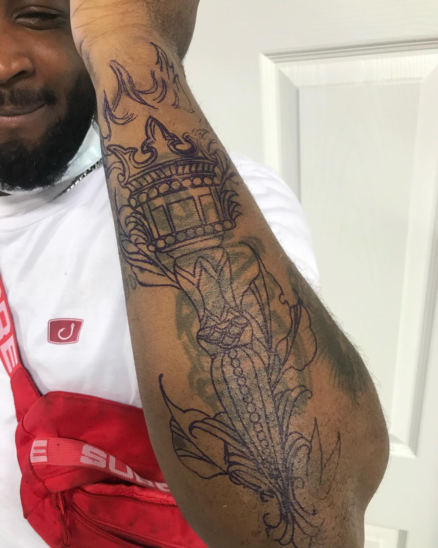 Lighthouse and floral black and grey tattoo on the forearm by Dre Inks