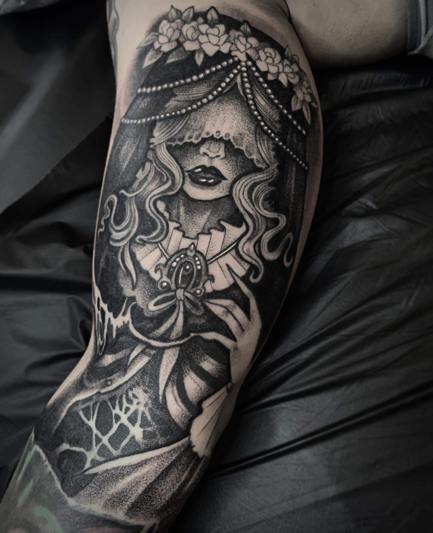 Woman with floral crown dotwork tattoo on the forearm by Briana Walker