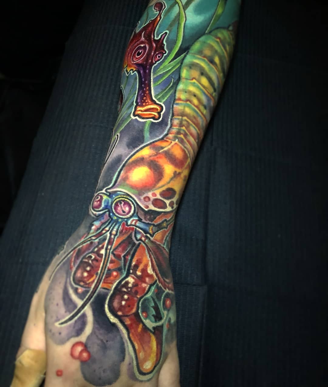 Squid surrealism tattoo on the forearm by Matt Driscoll
