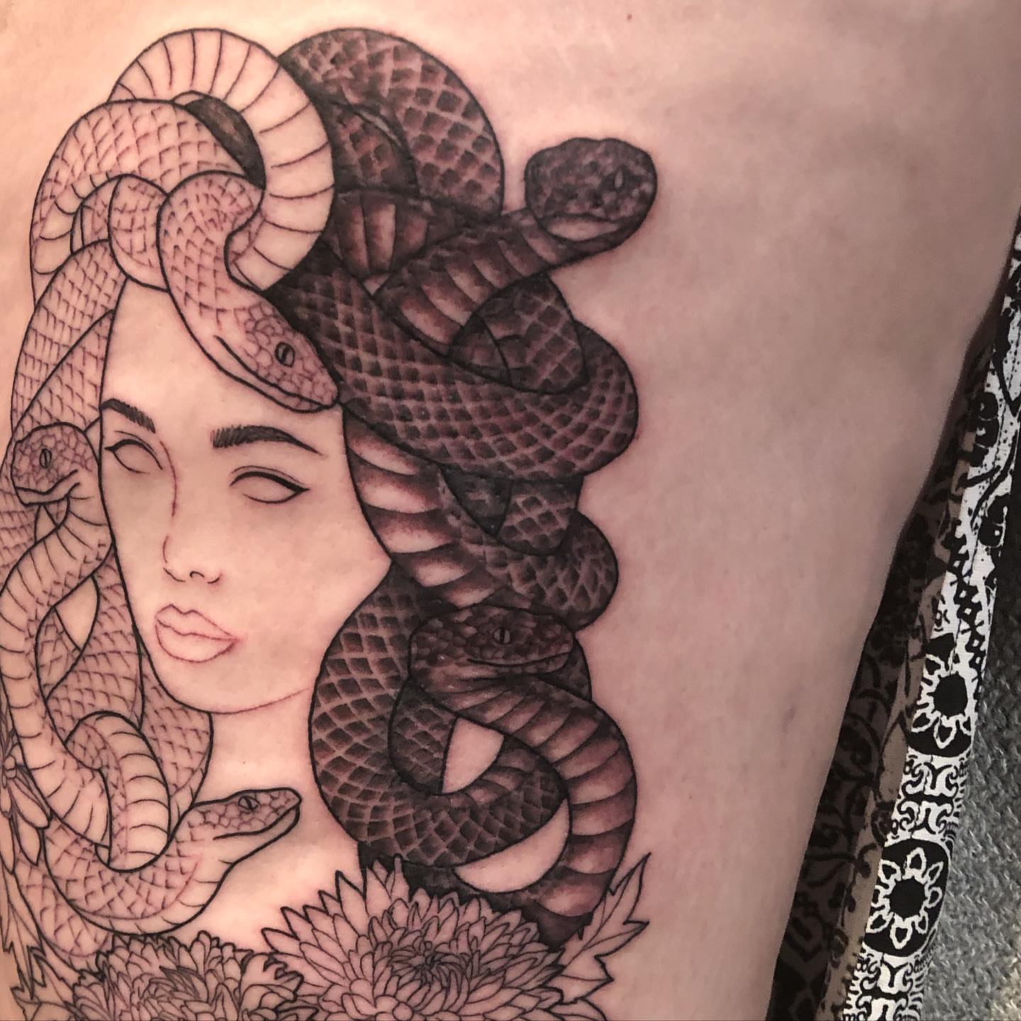 Medusa realism tattoo on the thigh by Emily Conner