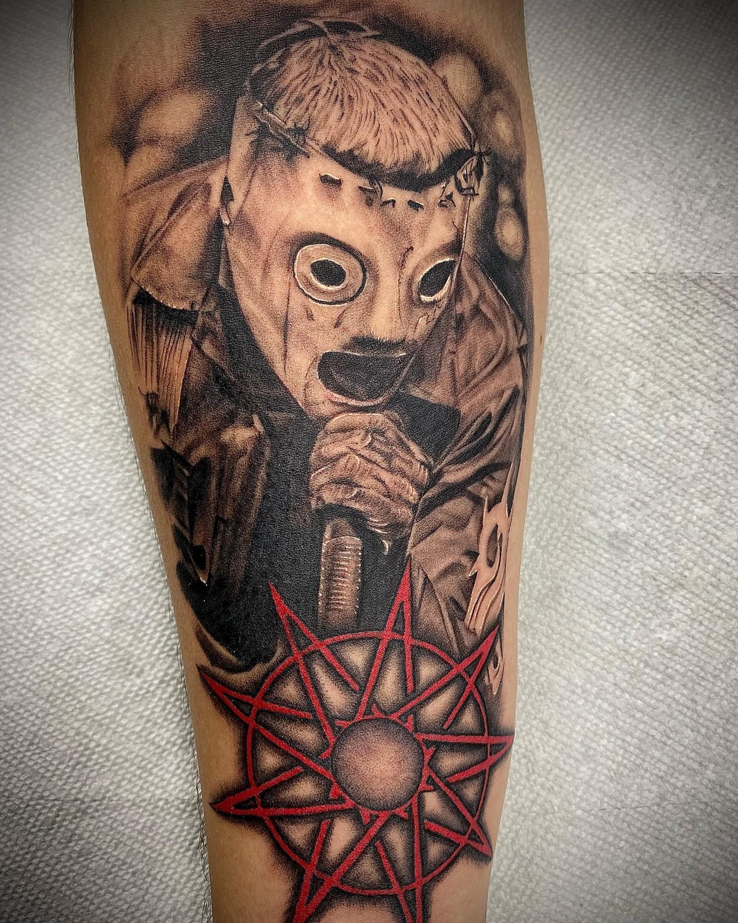 Mask and pentagram realism tattoo on the forearm by James Foltz