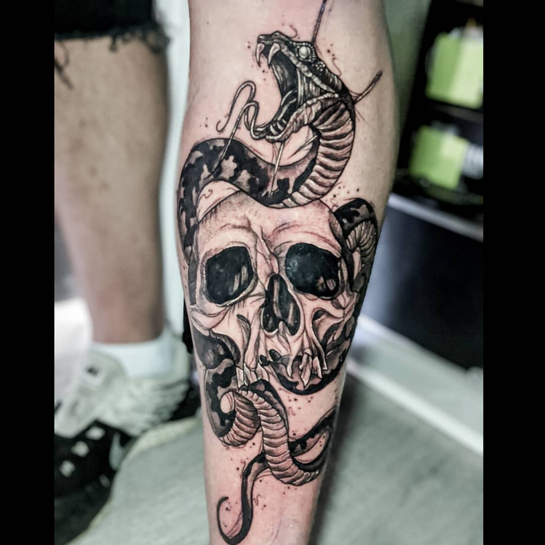 Skull and snake realism tattoo on the forearm by Elidia Veliz