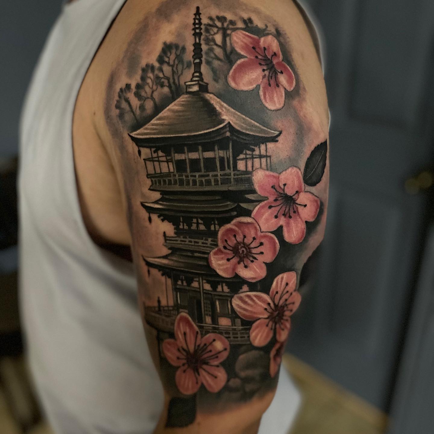 Cherry blossoms and pagoda japanese irezumi tattoo on the shoulder by Gary Graves