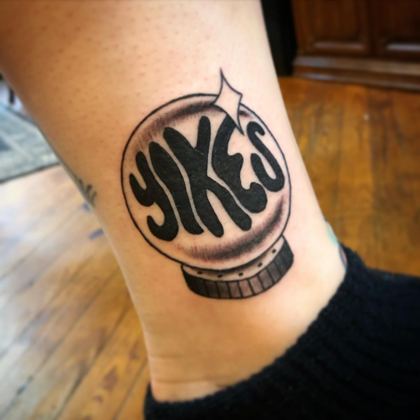 Yokes black and grey tattoo on the forearm by Dave Shurman