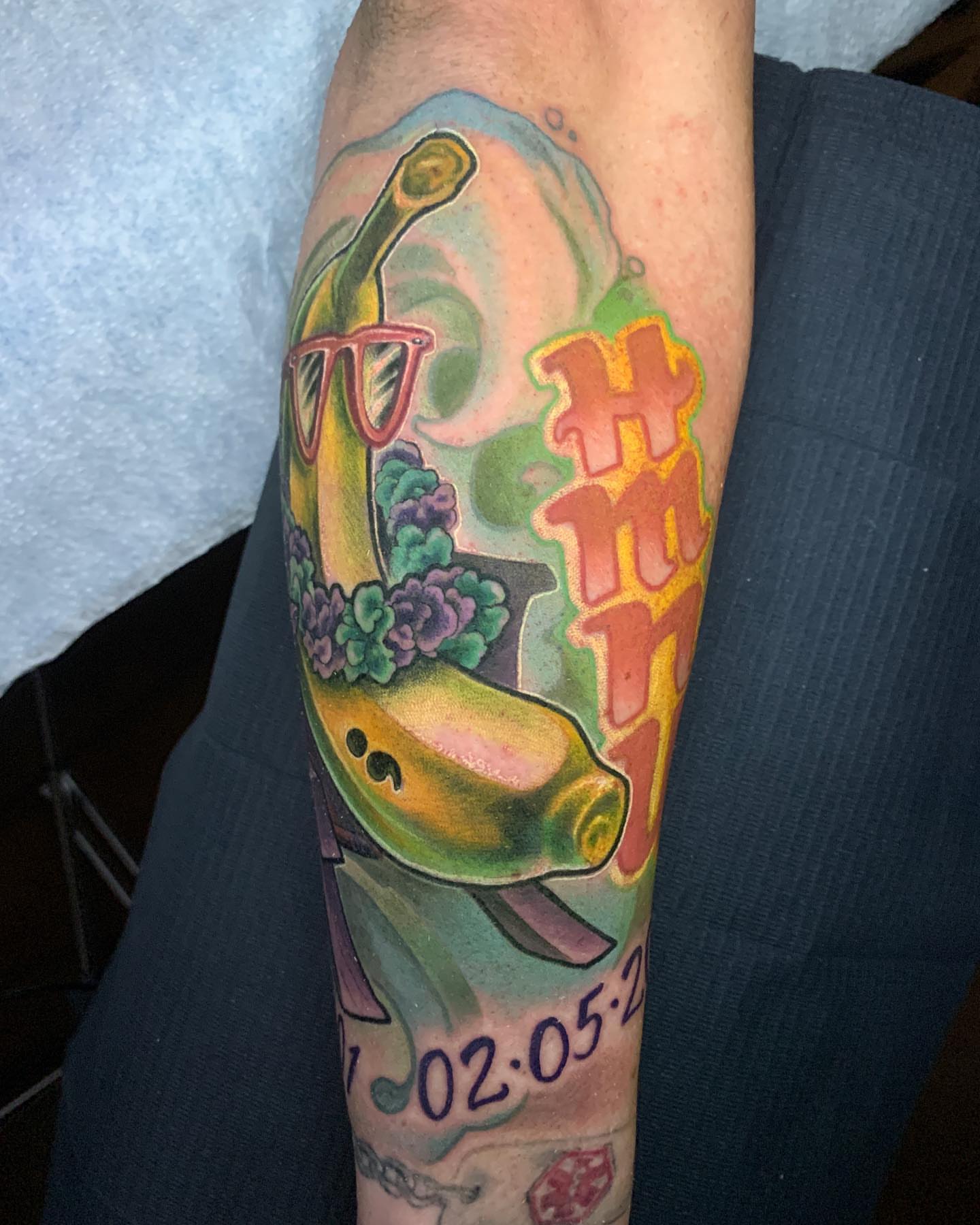 Dolphin with flowers American traditional tattoo on the forearm by Albuquerque Tattoo Artist, Albuquerque, New Mexico
