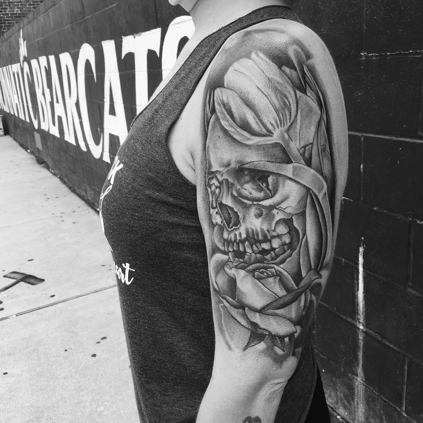 Skull with rose realism tattoo on the forearm by Brian Keith