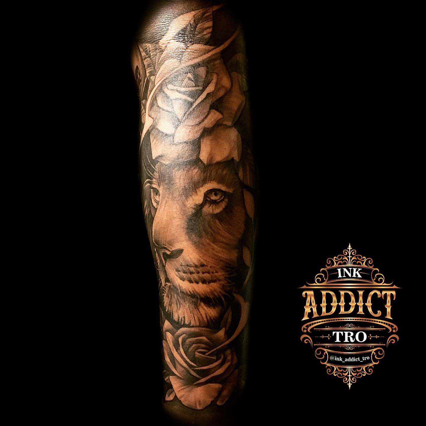 Lion and roses realism tattoo on the forearm by Trocon Talhouk