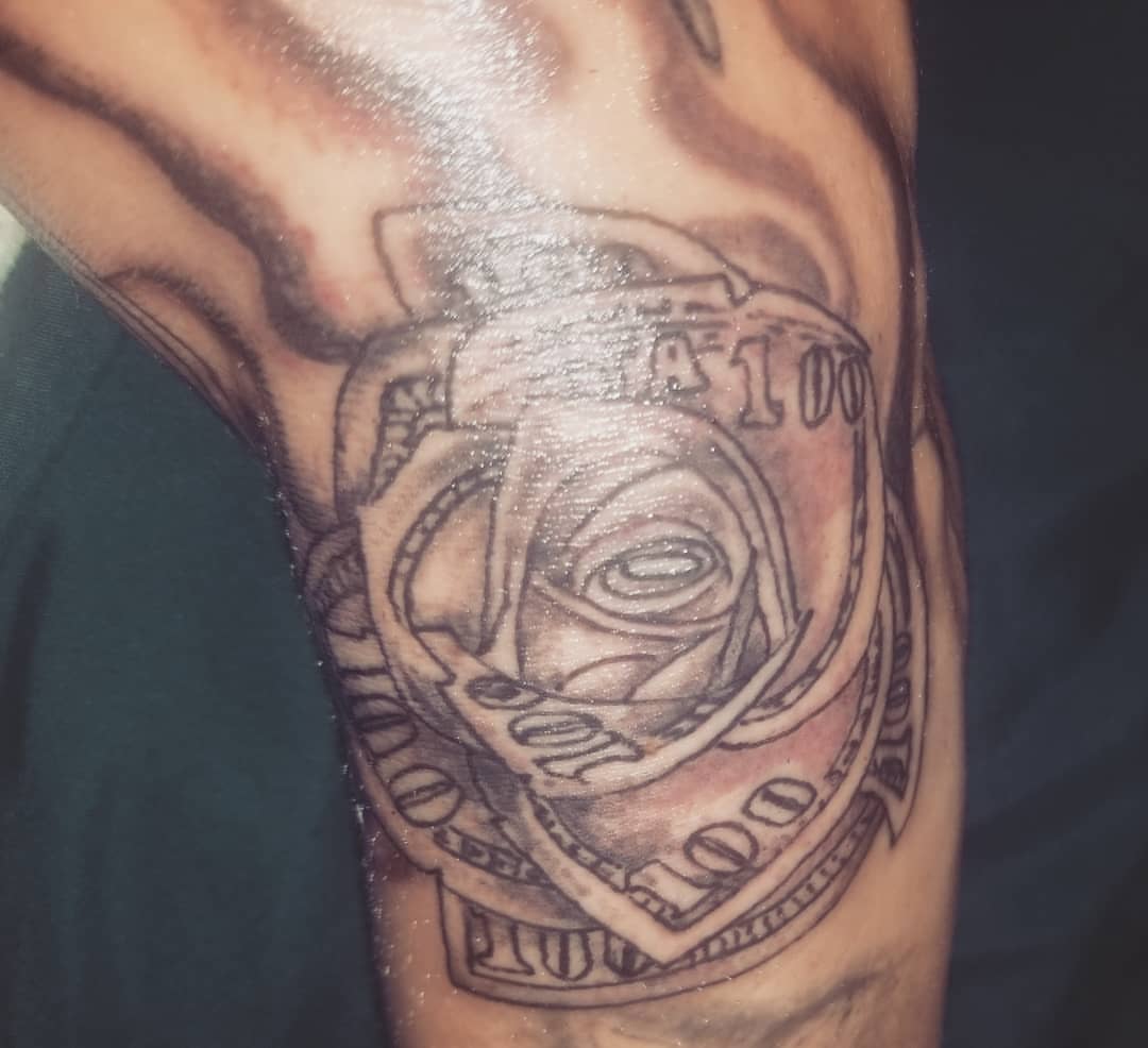 Money black and grey tattoo on the forearm by Louie Vee Guddah