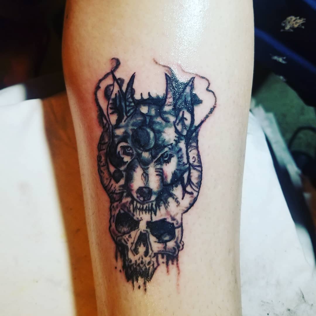 Wolf skull dark realism tattoo on the forearm by Louie Vee Guddah