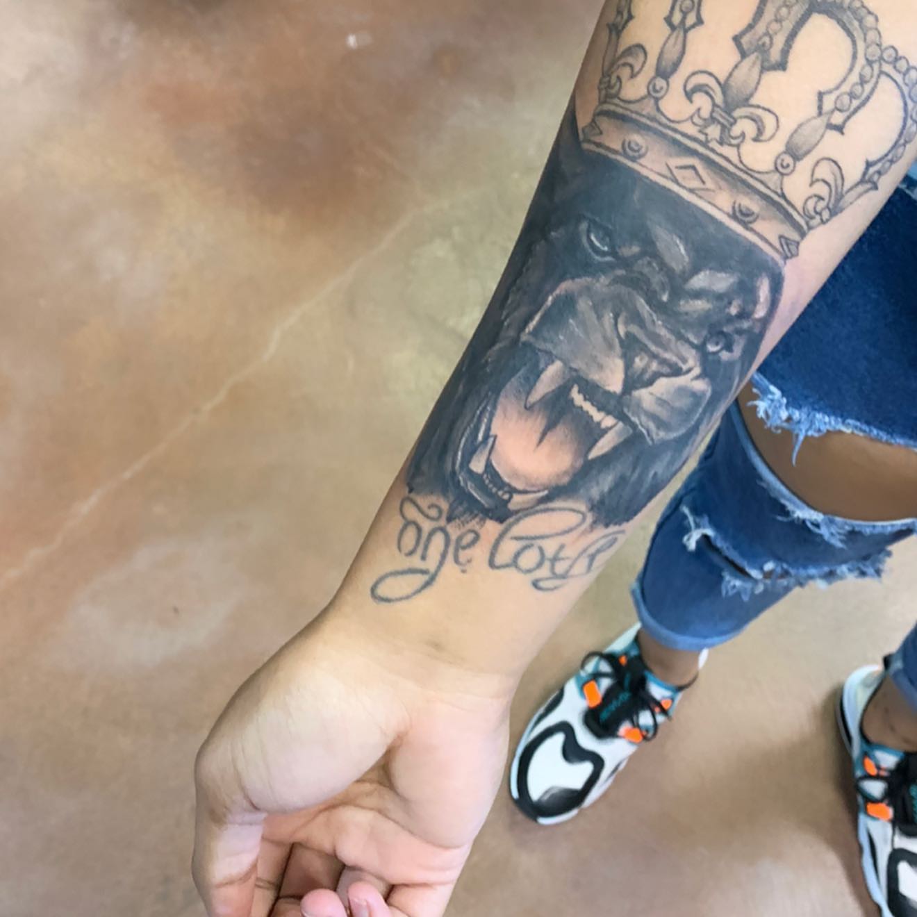 Lion with crown realism tattoo on the forearm by Mikeyftsk2