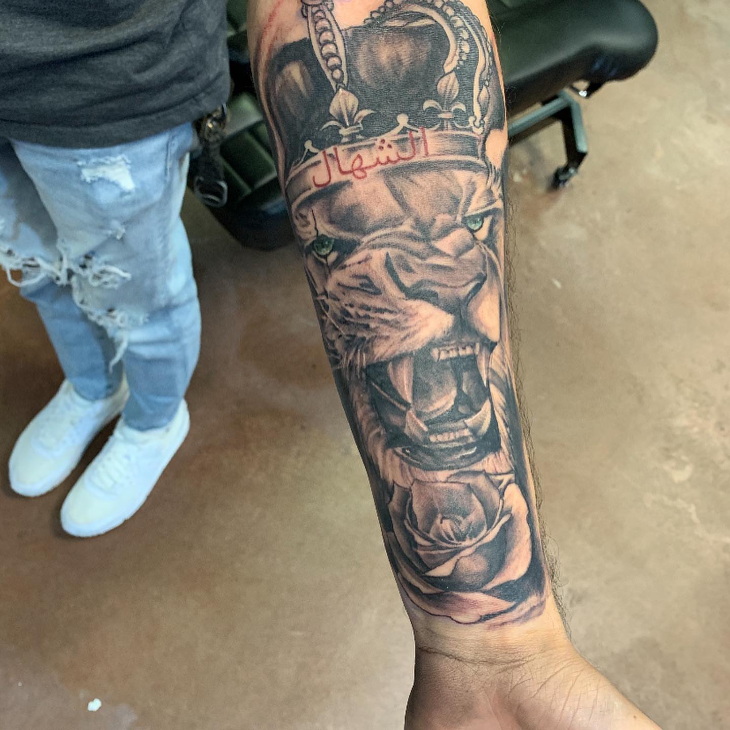 Lion with crown realism tattoo on the forearm by Mikeyftsk2