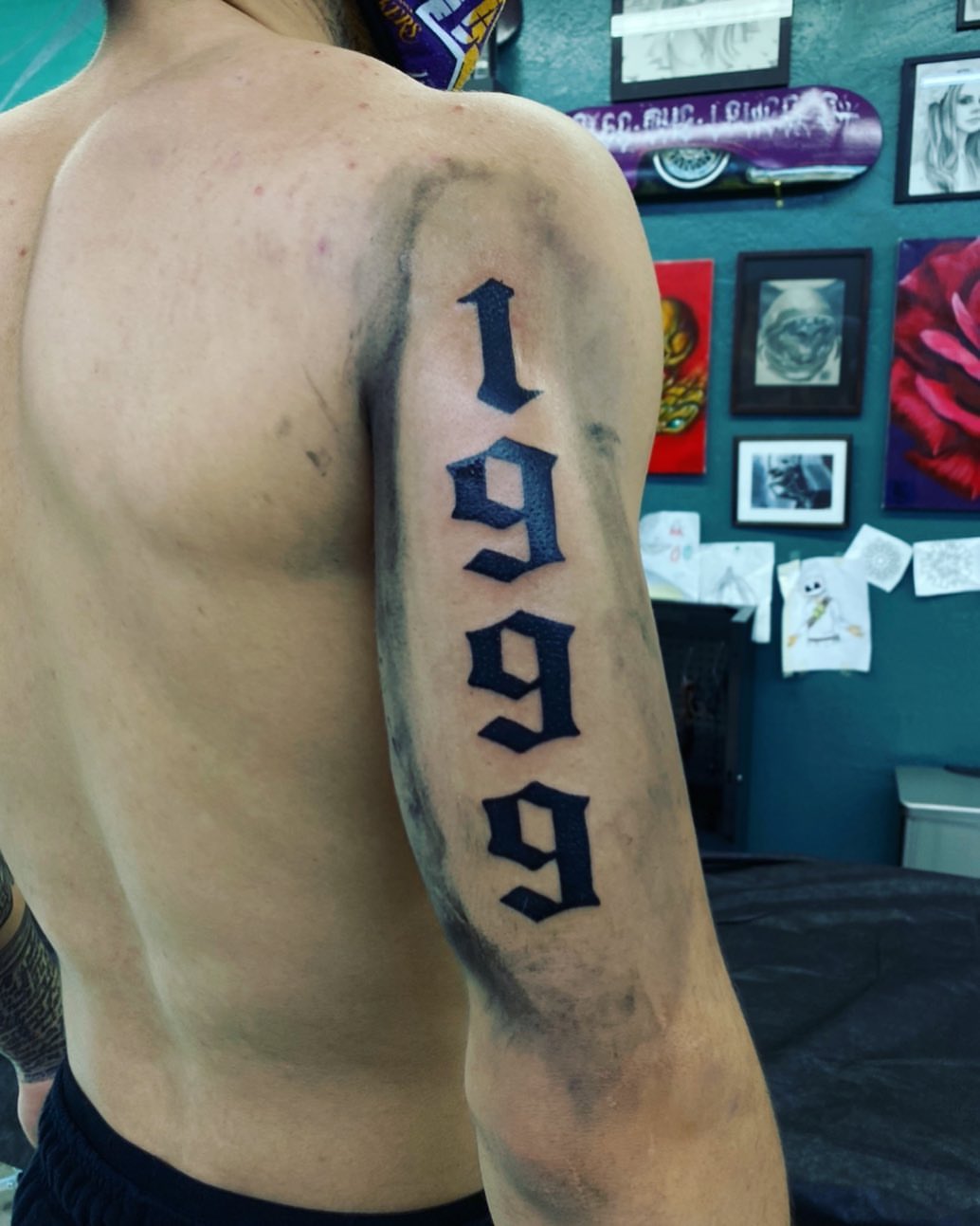 Numbers black and grey tattoo on the upper arm by Monique Ortiz, Mesa, Arizona
