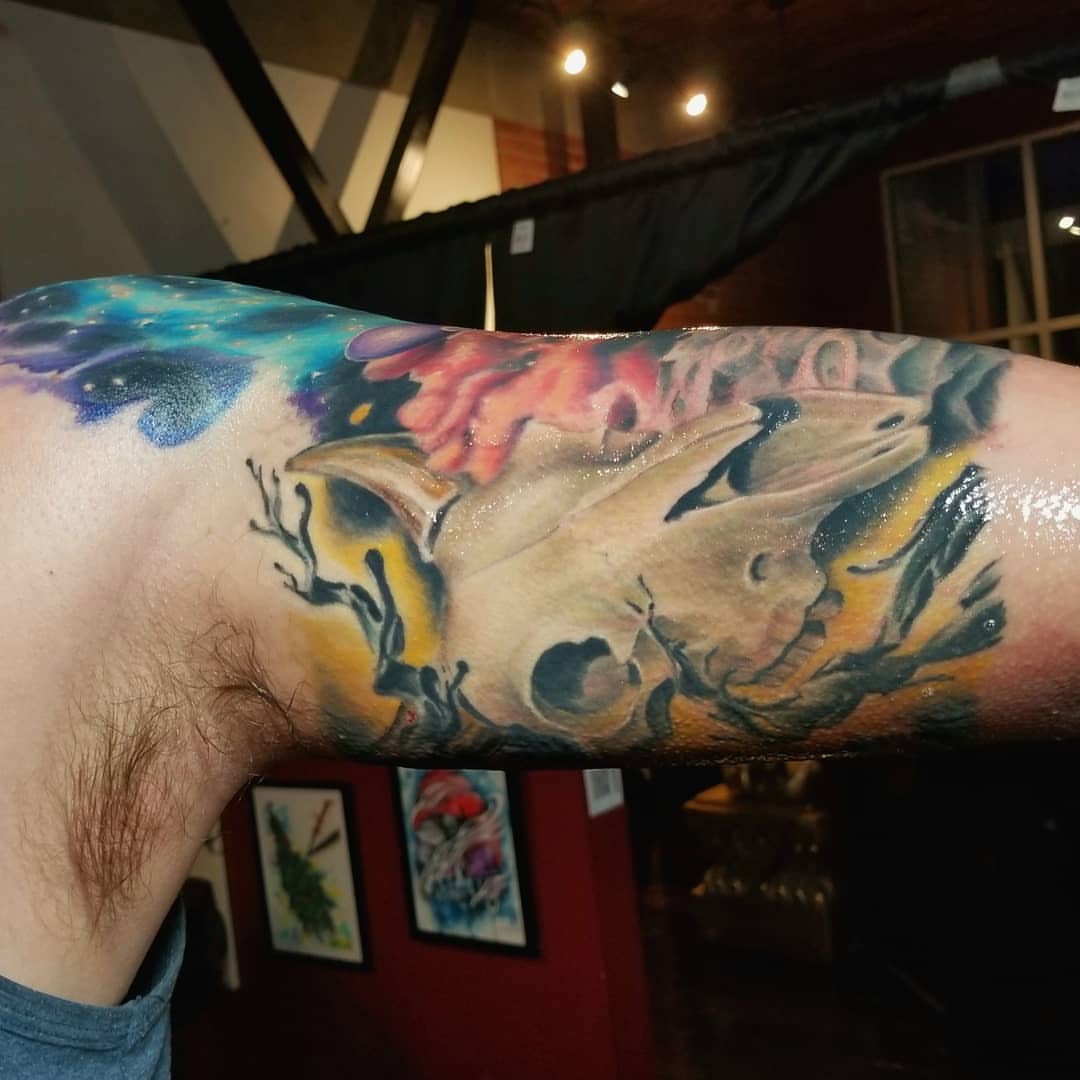 Skull and floral realism tattoo on the forearm by Jake Goss, Salt Lake City, Utah