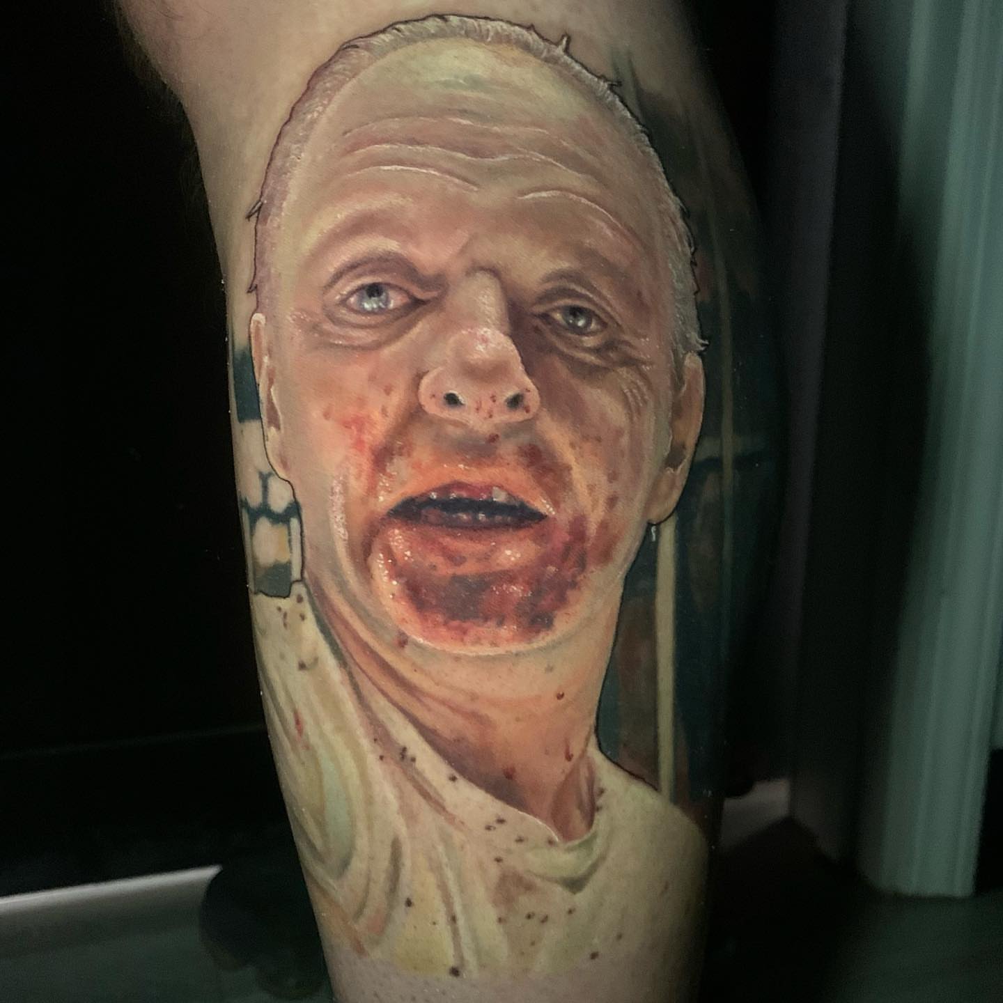 Man's face realism tattoo on the forearm by Amber Joy (AJ)