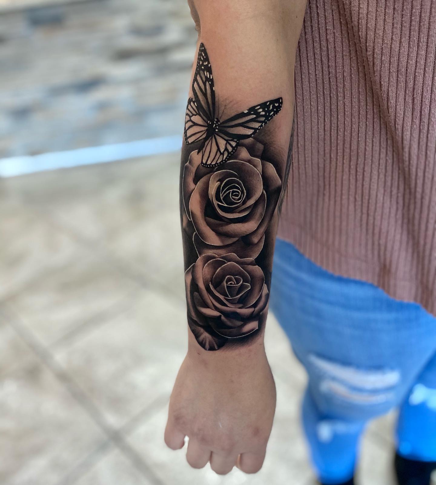 Roses and butterfly realism tattoo on the forearm by Aaron Carey, Salem, Oregon