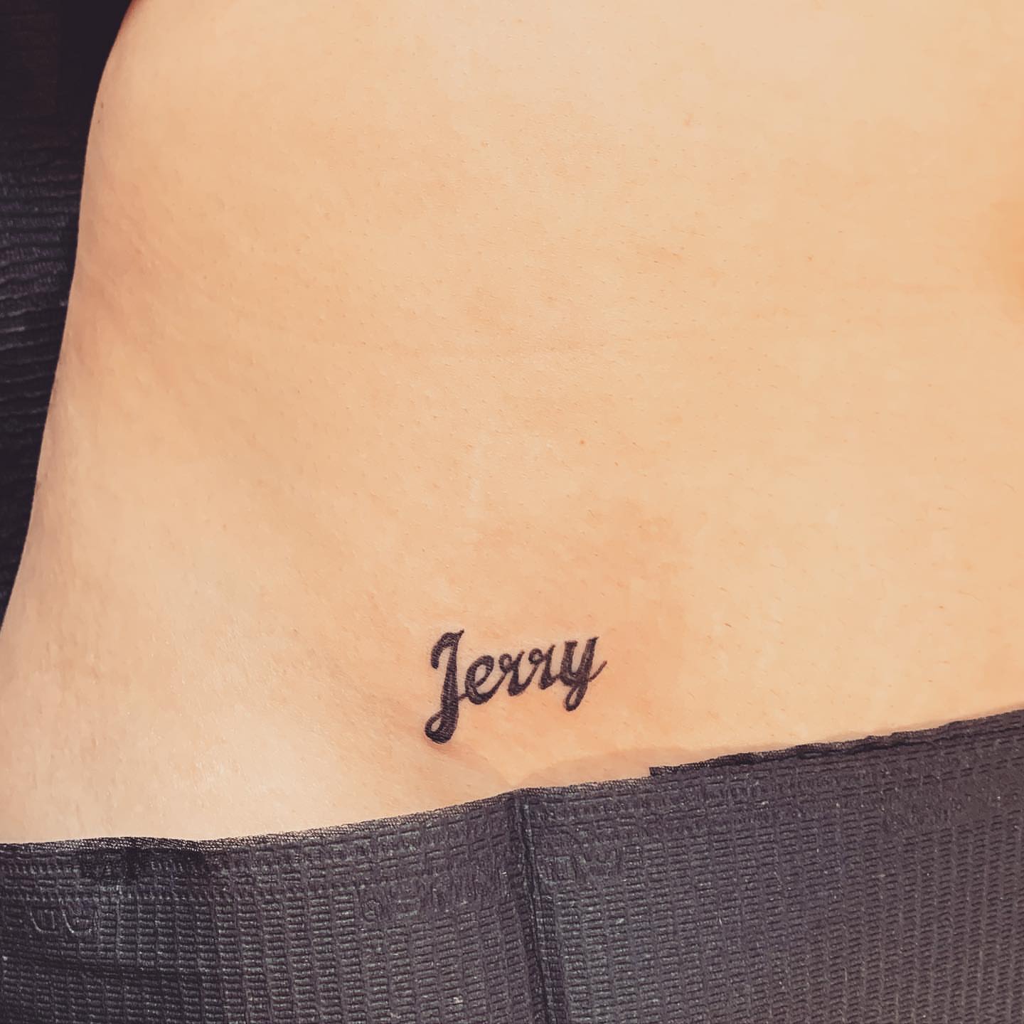 Jerry lettering script tattoo on the torso by Rhonda Faber Green