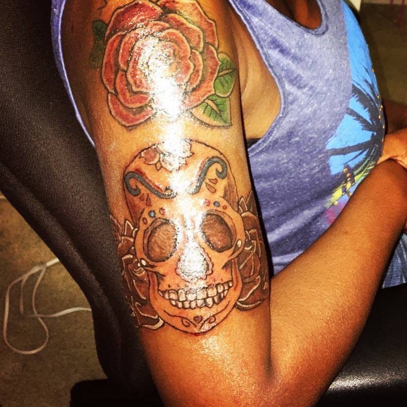 Sugar skull with rose Chicano tattoo on the thigh by Danimals