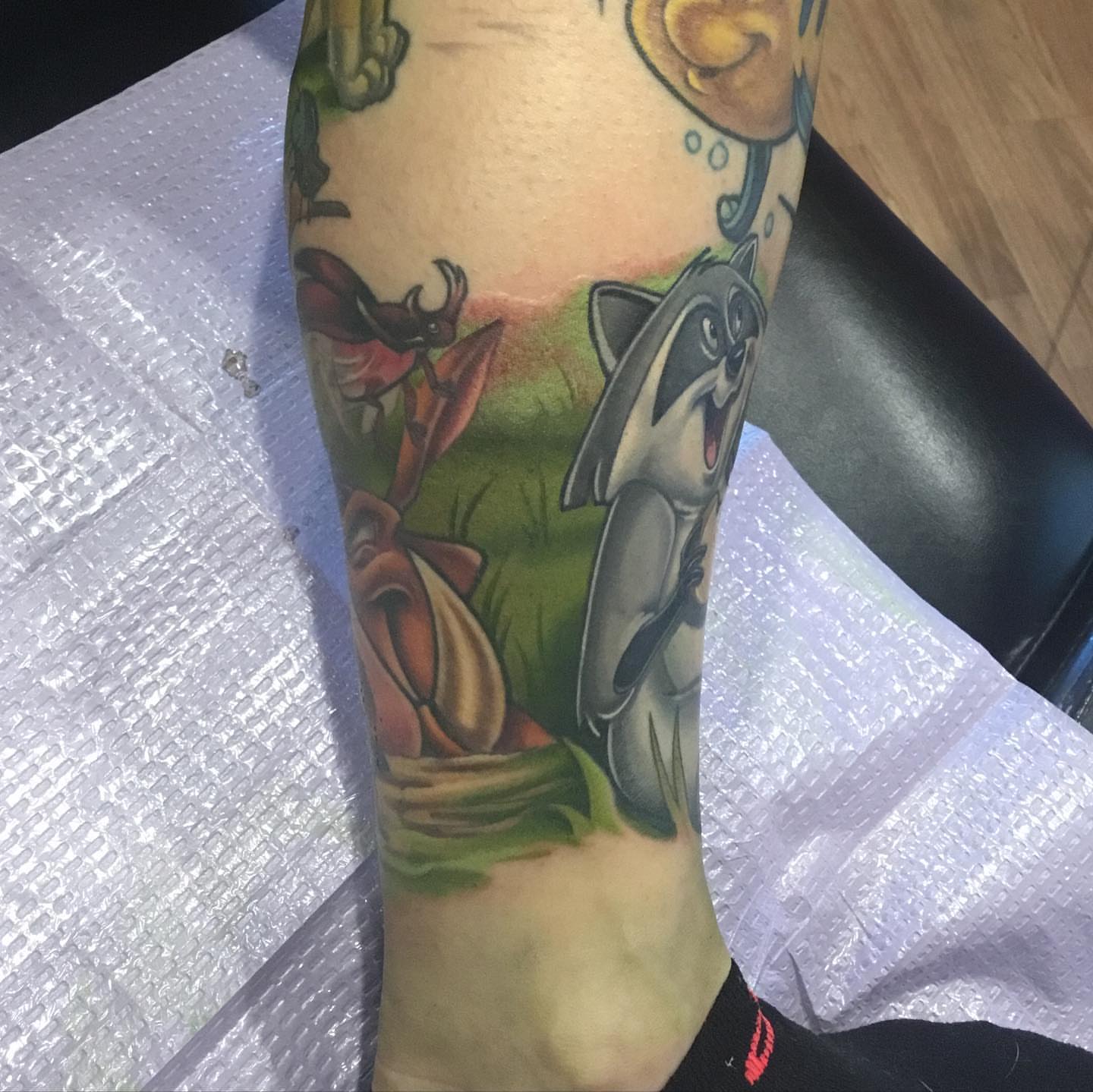 Raccoon and frog realism tattoo on the forearm by Ariel Robinson
