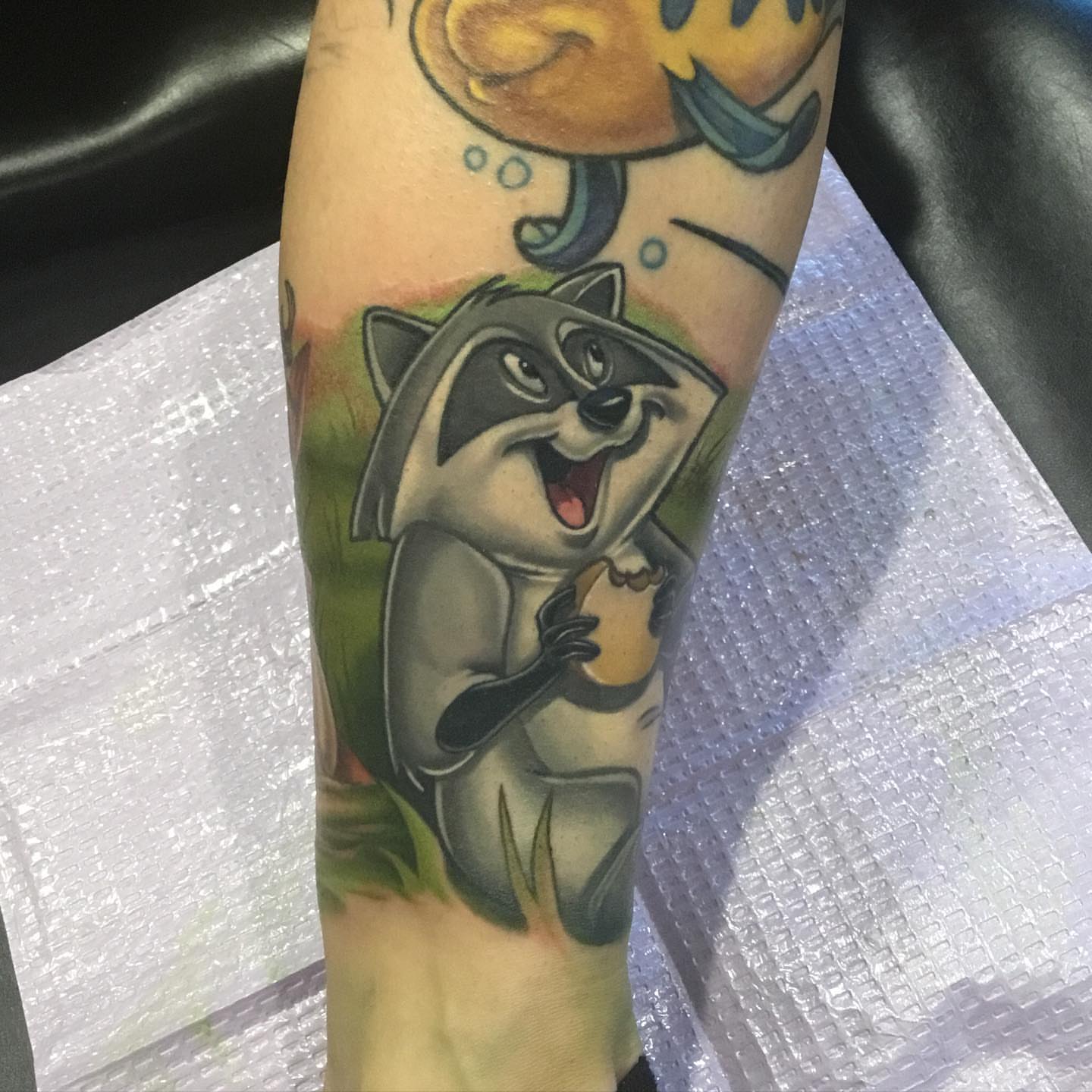 Raccoon American traditional tattoo on the forearm by Ariel Robinson