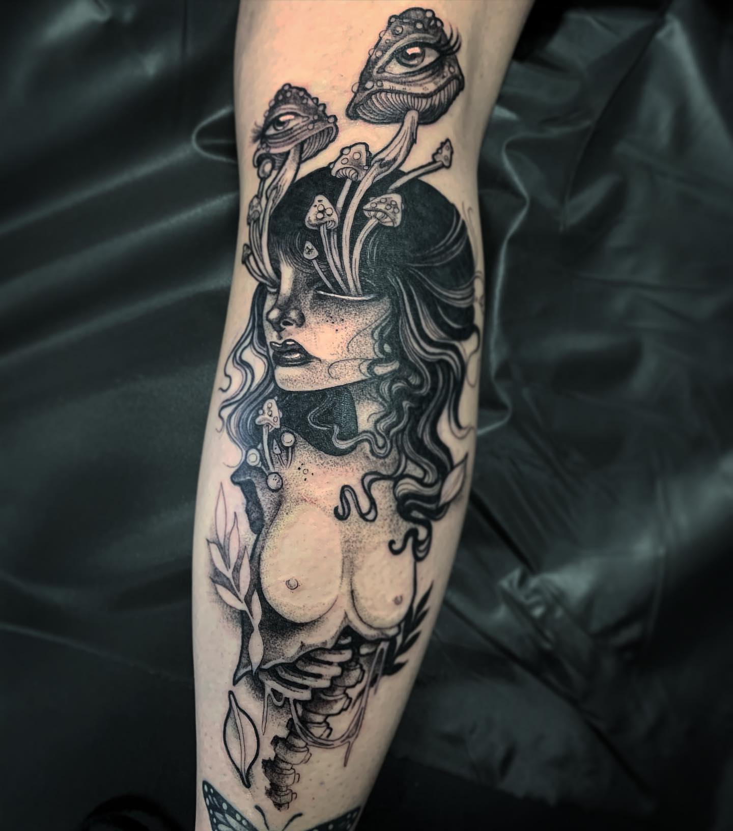 Woman with mushrooms dotwork tattoo on the forearm by Briana Walker