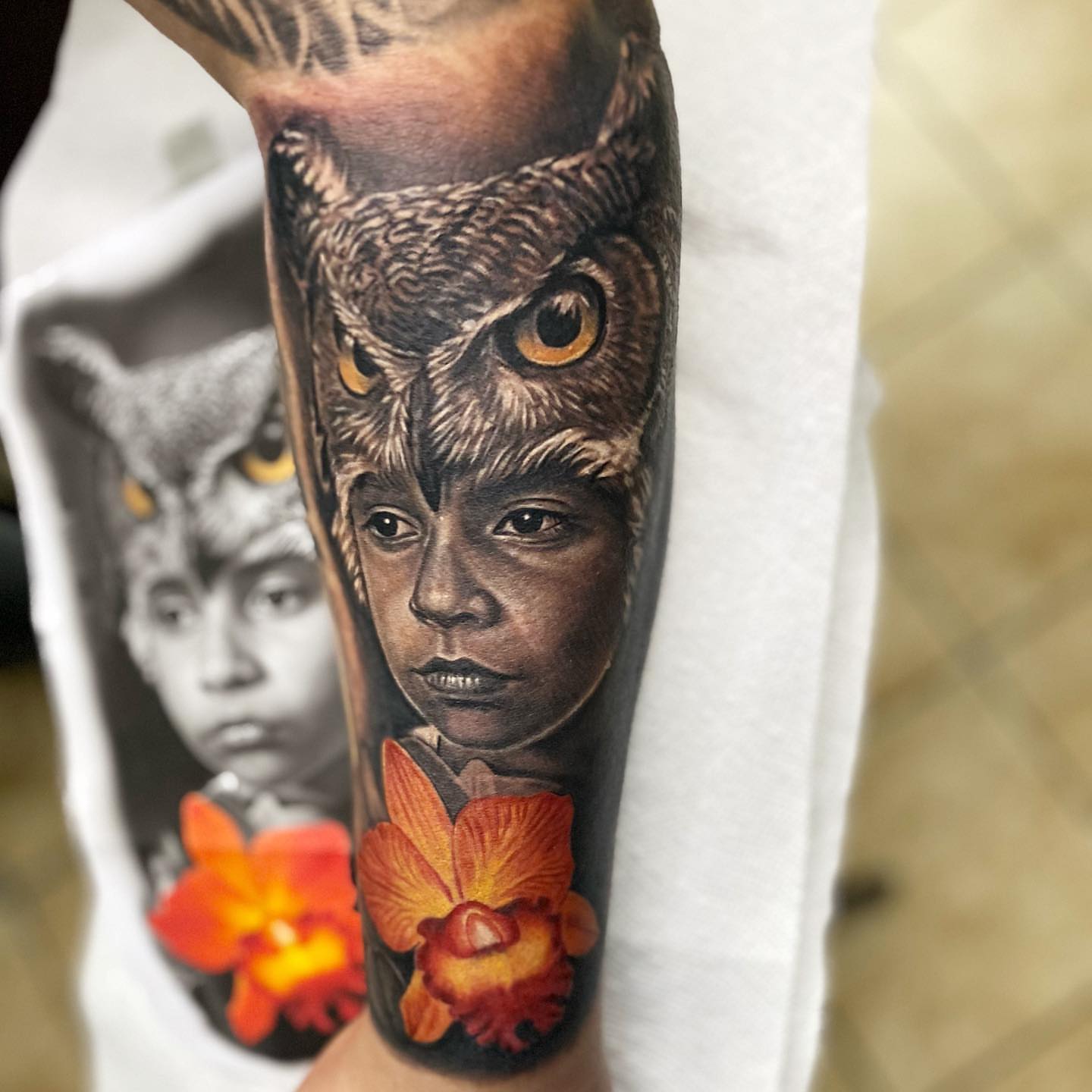 Owl and child realism tattoo on the forearm by Gary Graves