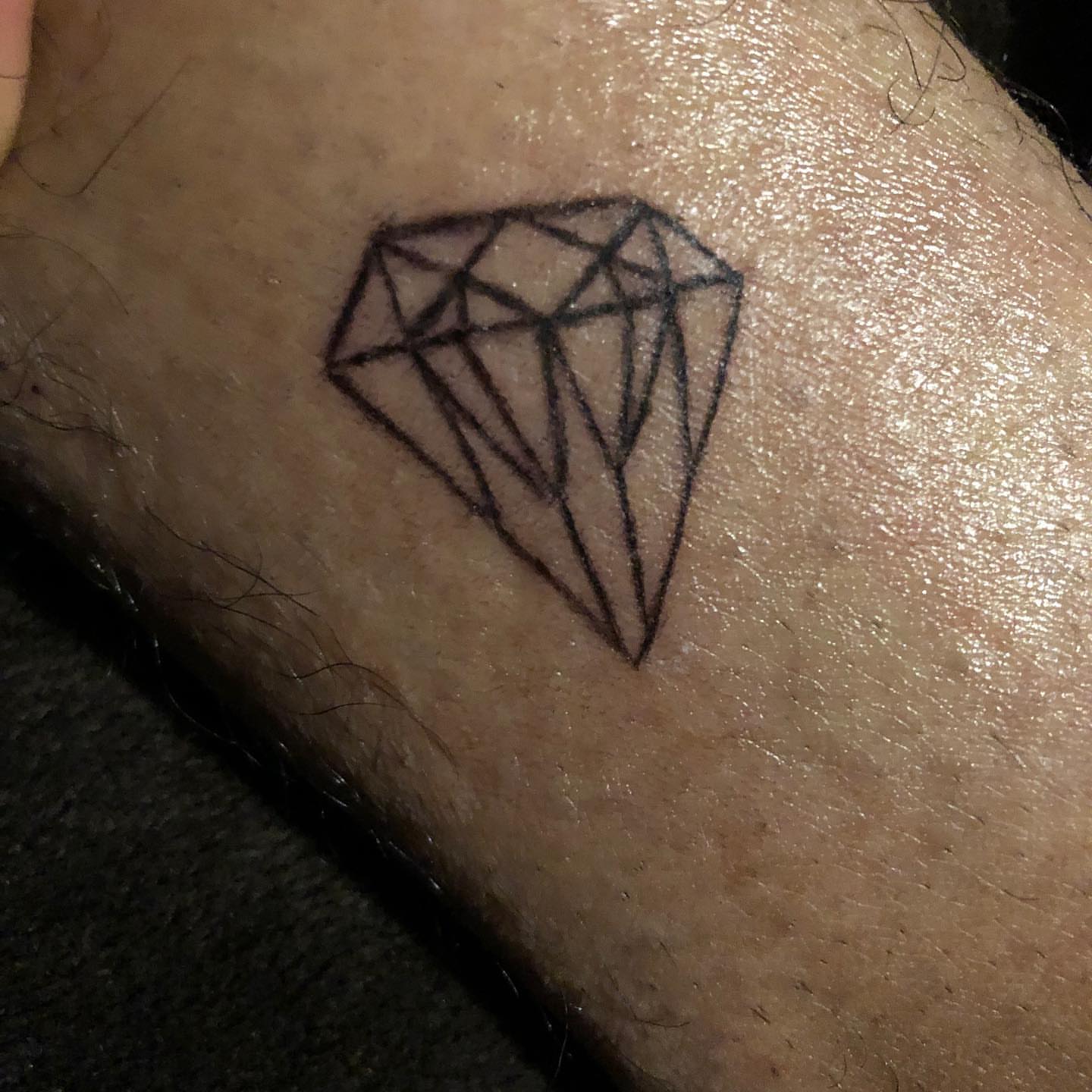 Diamond geometric tattoo on the forearm by Daniel Monyongo