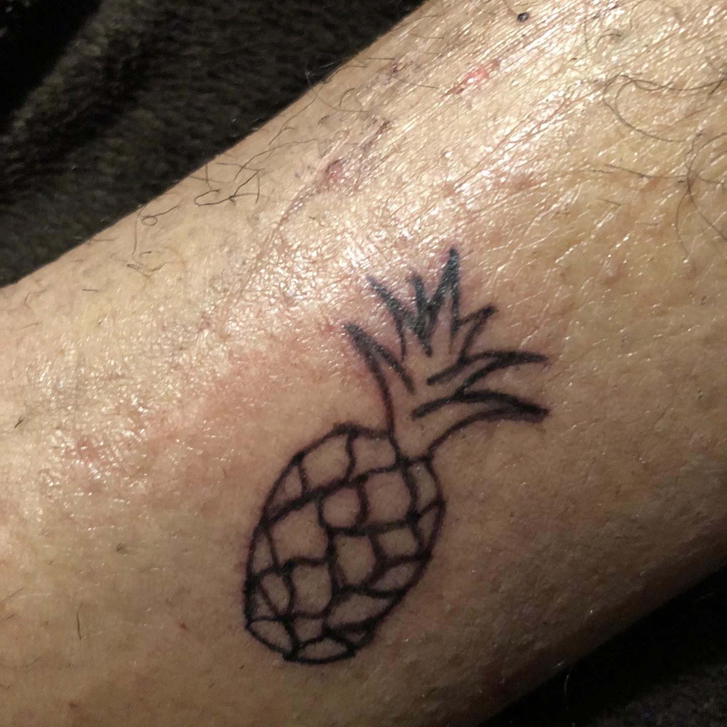 Pineapple black and grey tattoo on the forearm by Daniel Monyongo