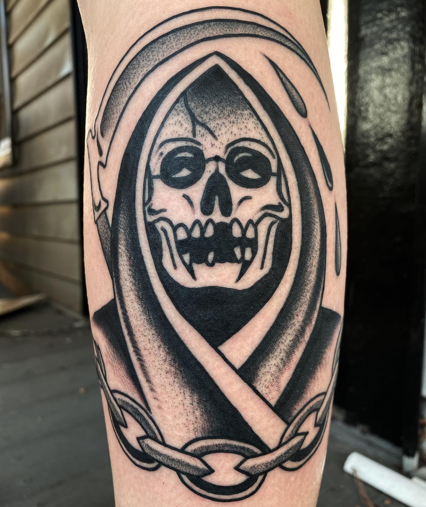 Grim reaper black and grey tattoo on the forearm by Daniel Mesen