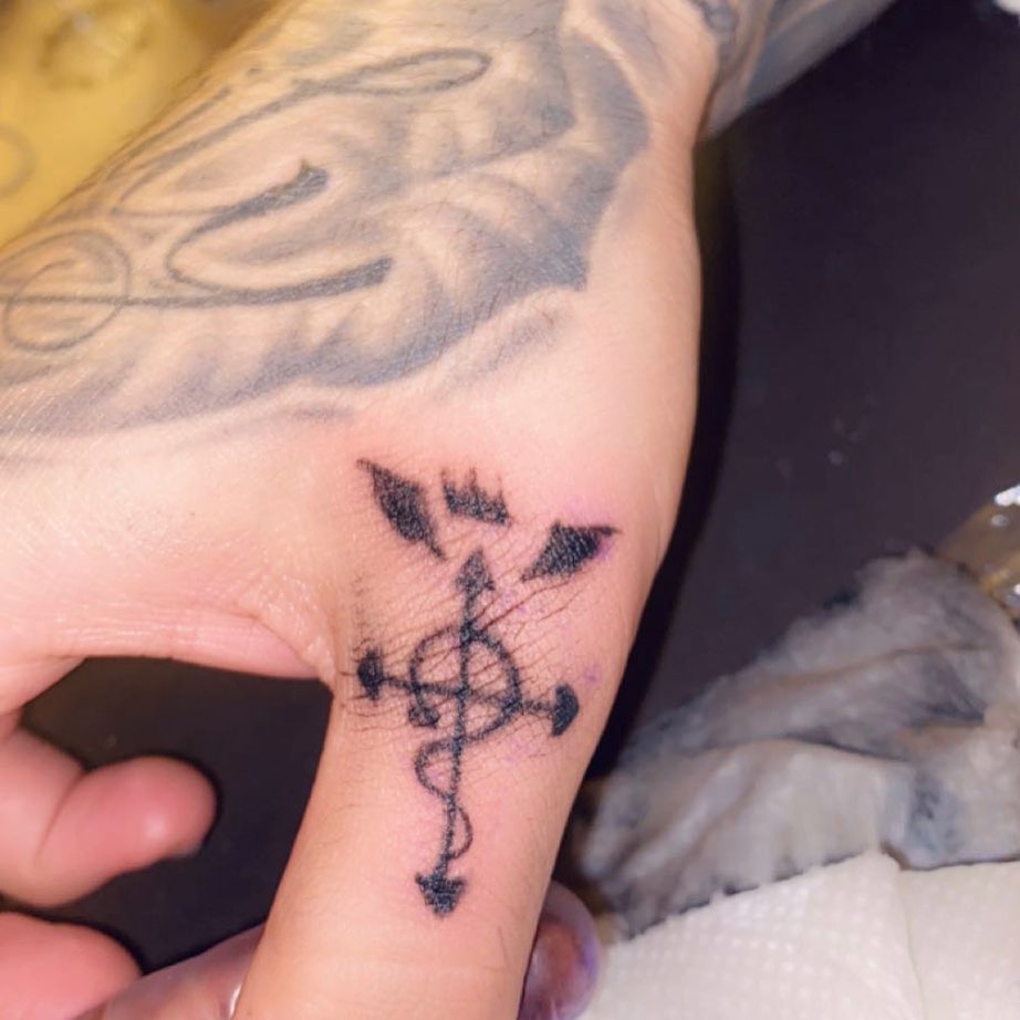 Cross with wings geometric tattoo on the hand by Daniel Monyongo
