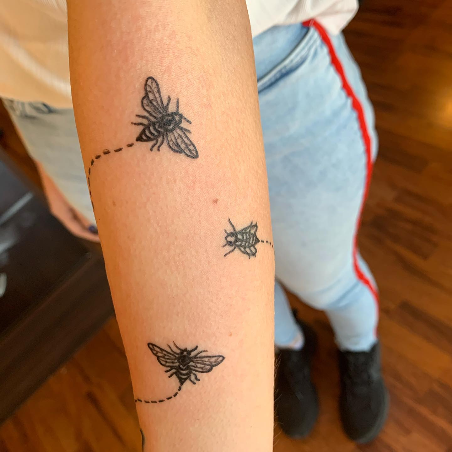 Bees black and grey tattoo on the forearm by Rhonda Faber Green