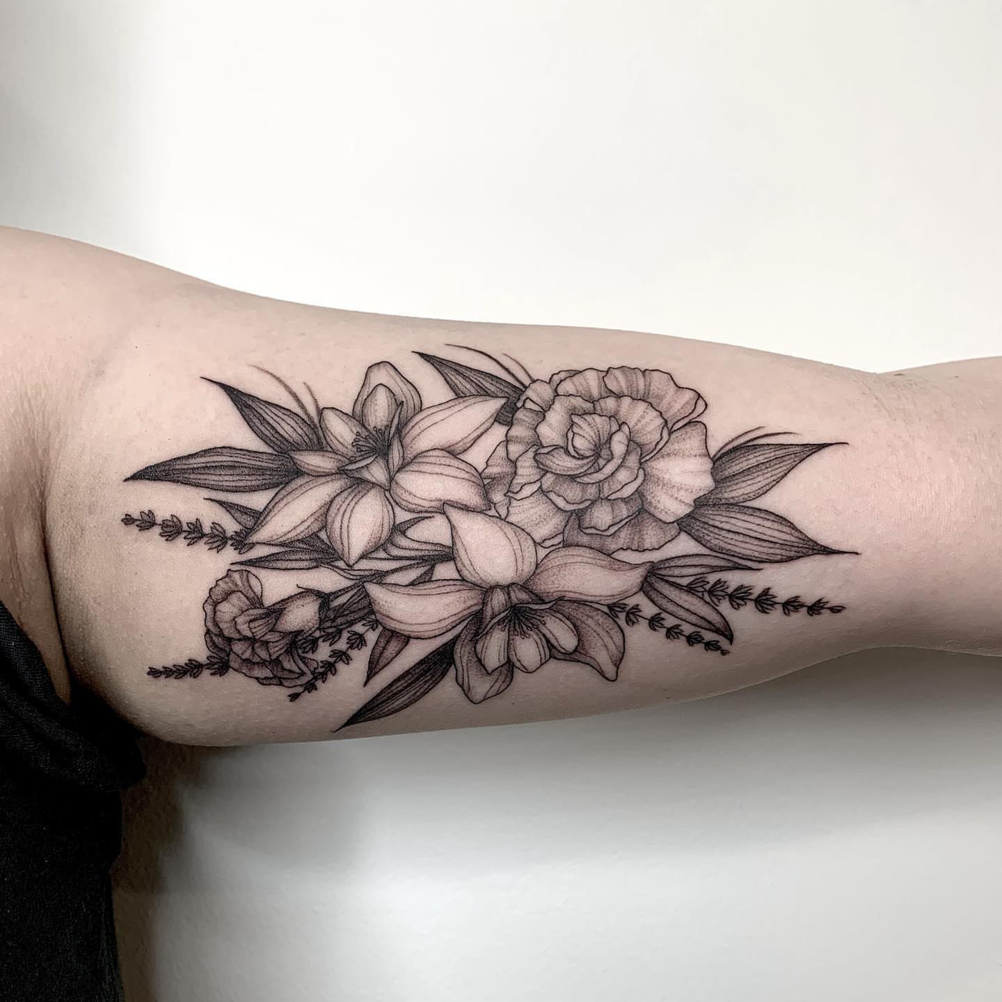 Floral bouquet realism tattoo on the forearm by Chelsea Darling