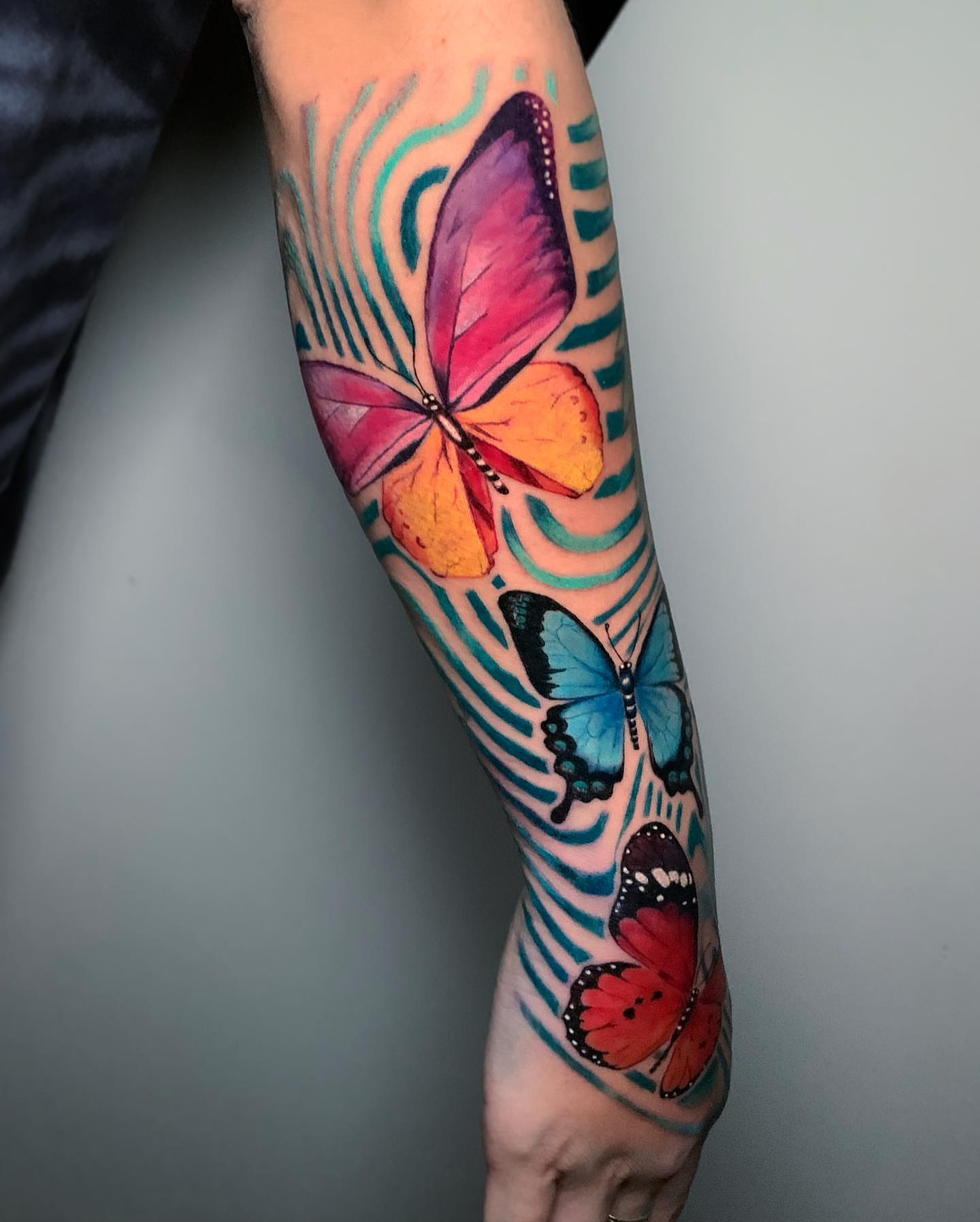 Butterflies watercolor tattoo on the forearm by Christian Pelaez