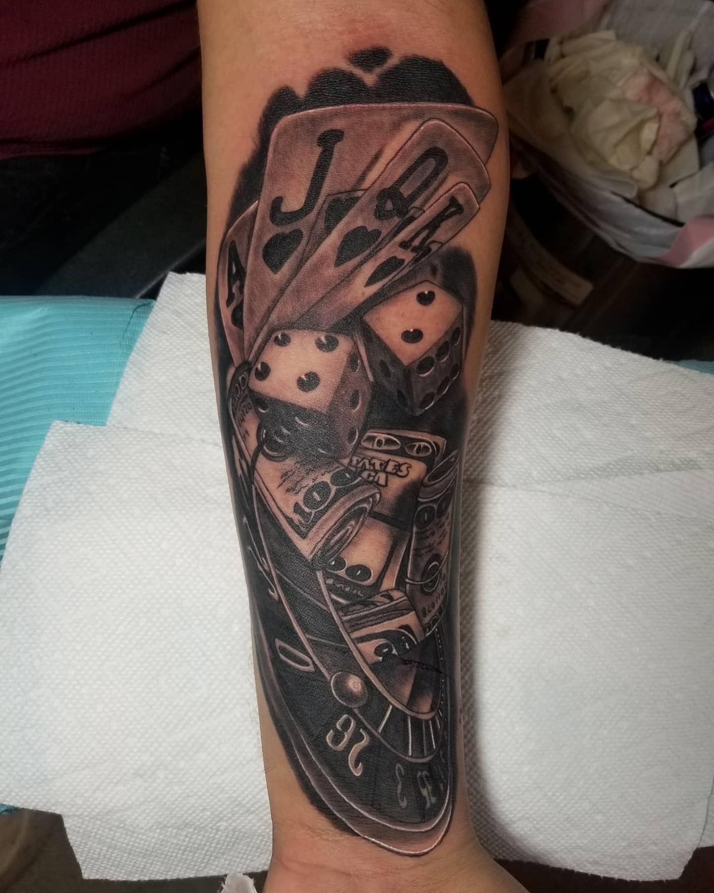 Playing cards and dice realism tattoo on the forearm by Miguel-C, Houston, Texas