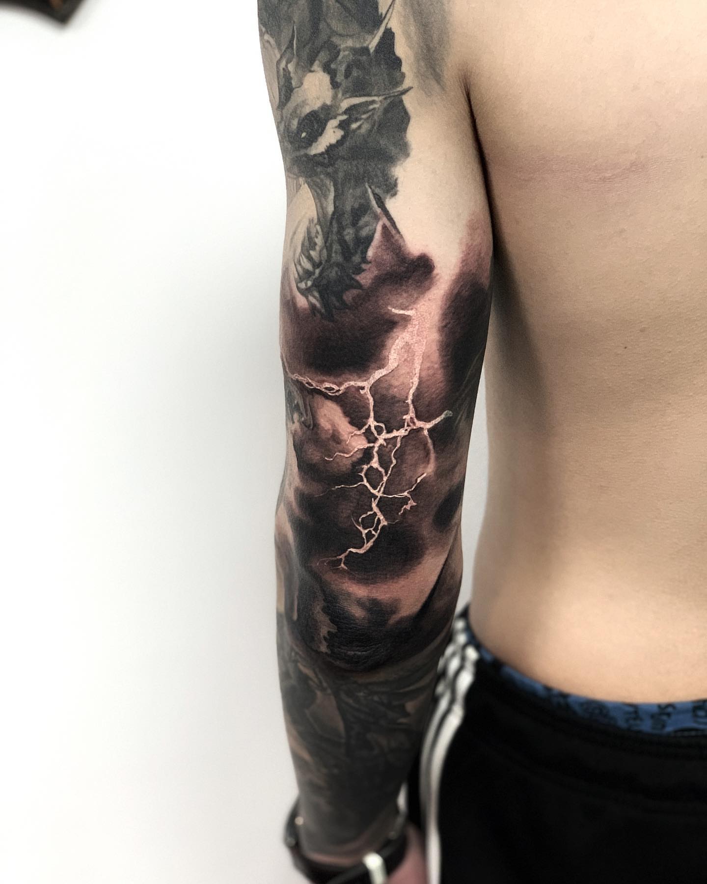 Storm cloud with lightning realism tattoo on the forearm by Anastasia Ritova