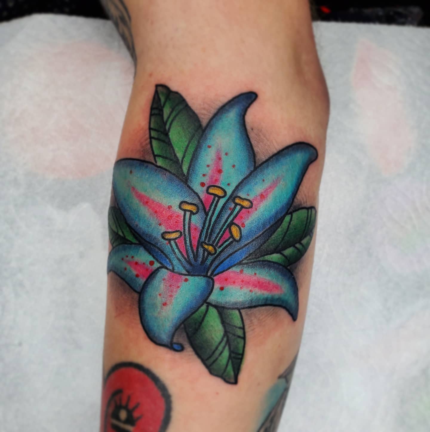 Lily American traditional tattoo on the forearm by TattoosbyPhatboi