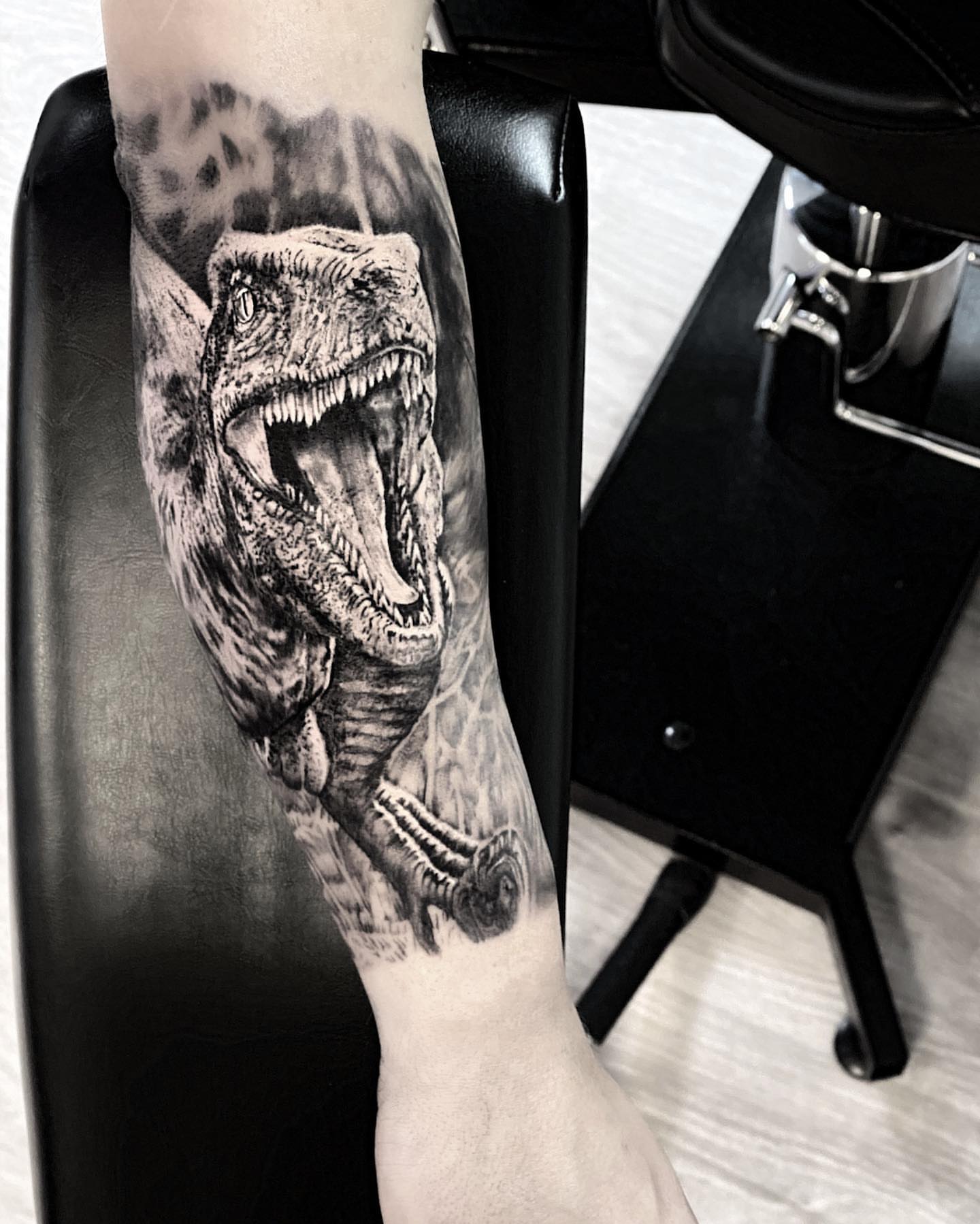 T-rex realism tattoo on the forearm by Robin Spitschan