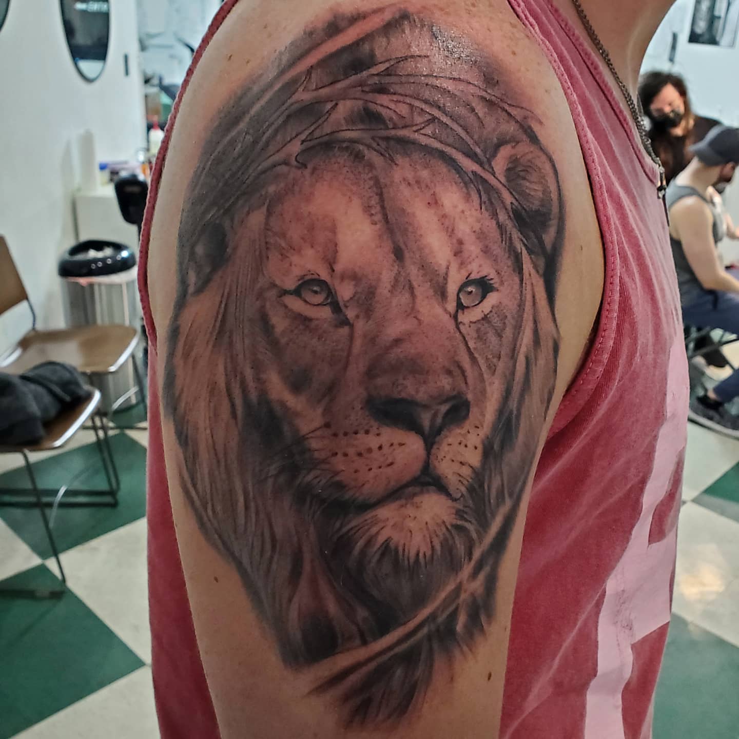 Lion realism tattoo on the upper arm by David Nash, Evansville, Indiana