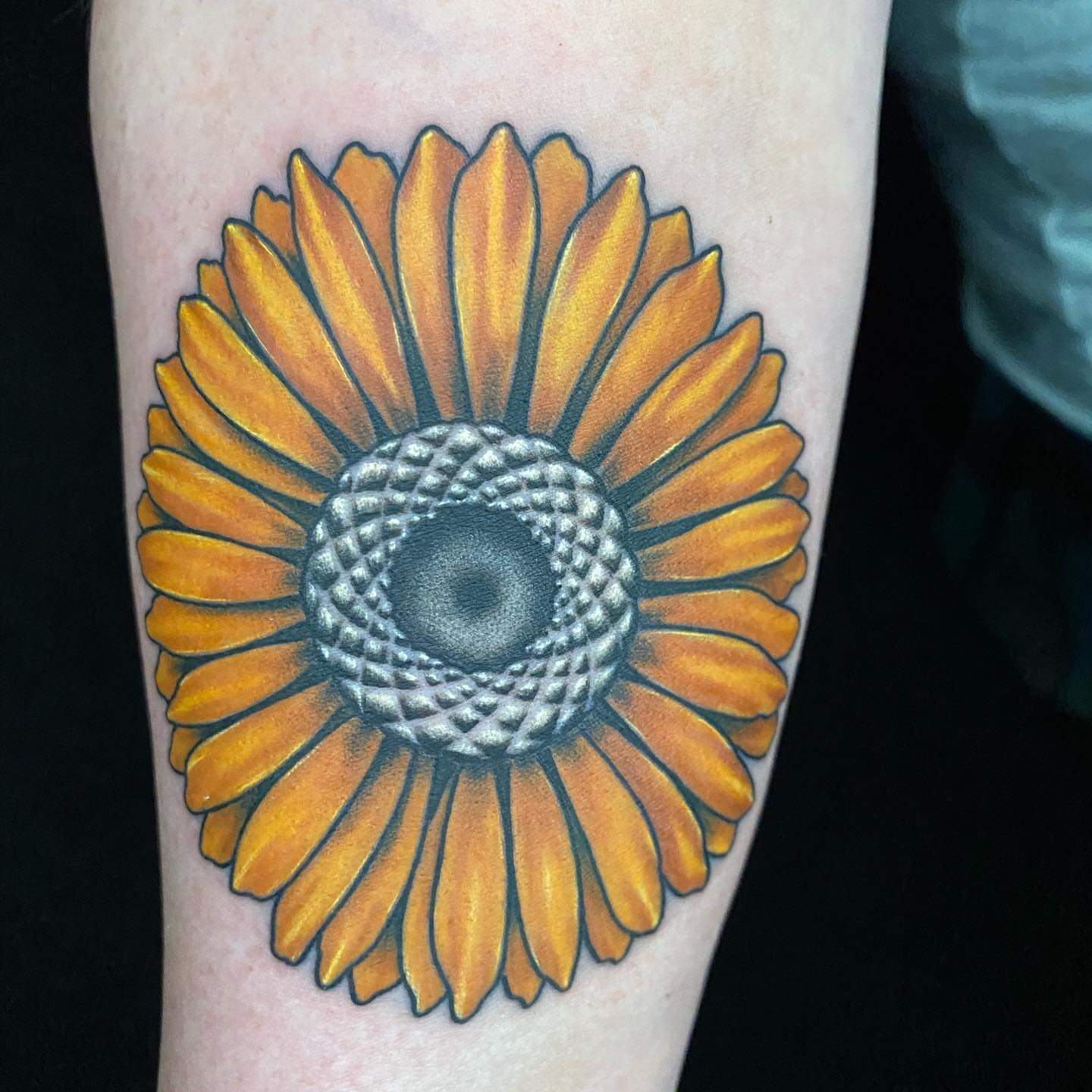 Sunflower realism tattoo on the forearm by Dustin Lane Collins
