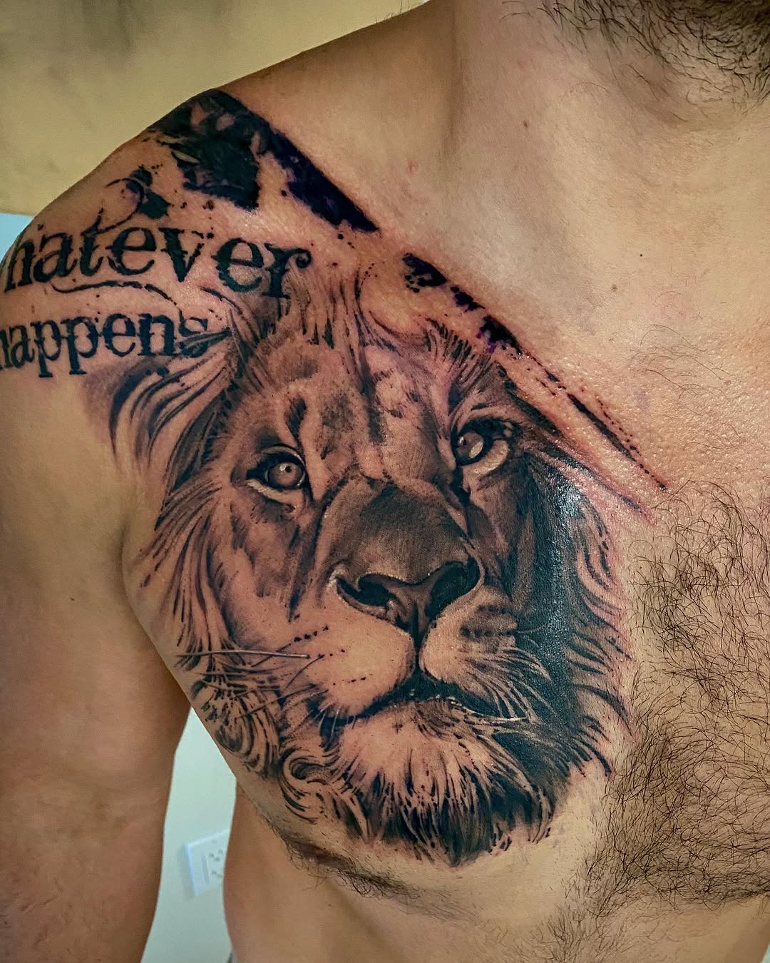 Lion head with text realism tattoo on the shoulder by David Garner, Los Angeles, California