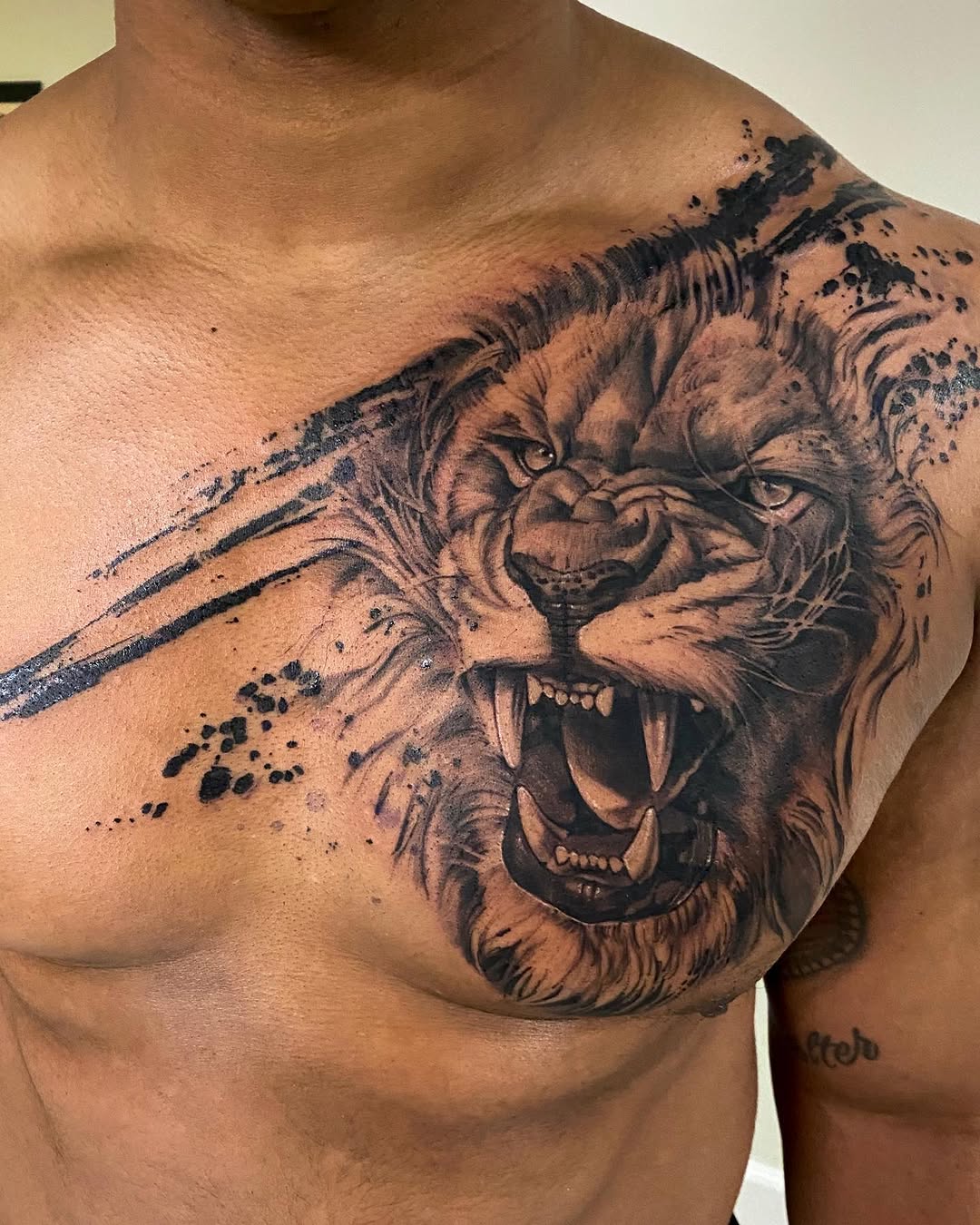 Roaring lion face realism tattoo on the chest by David Garner, Los Angeles, California
