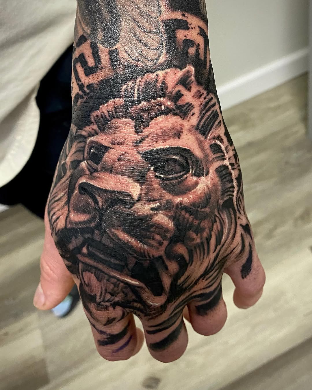 Lion head realism tattoo on the hand by David Garner, Los Angeles, California