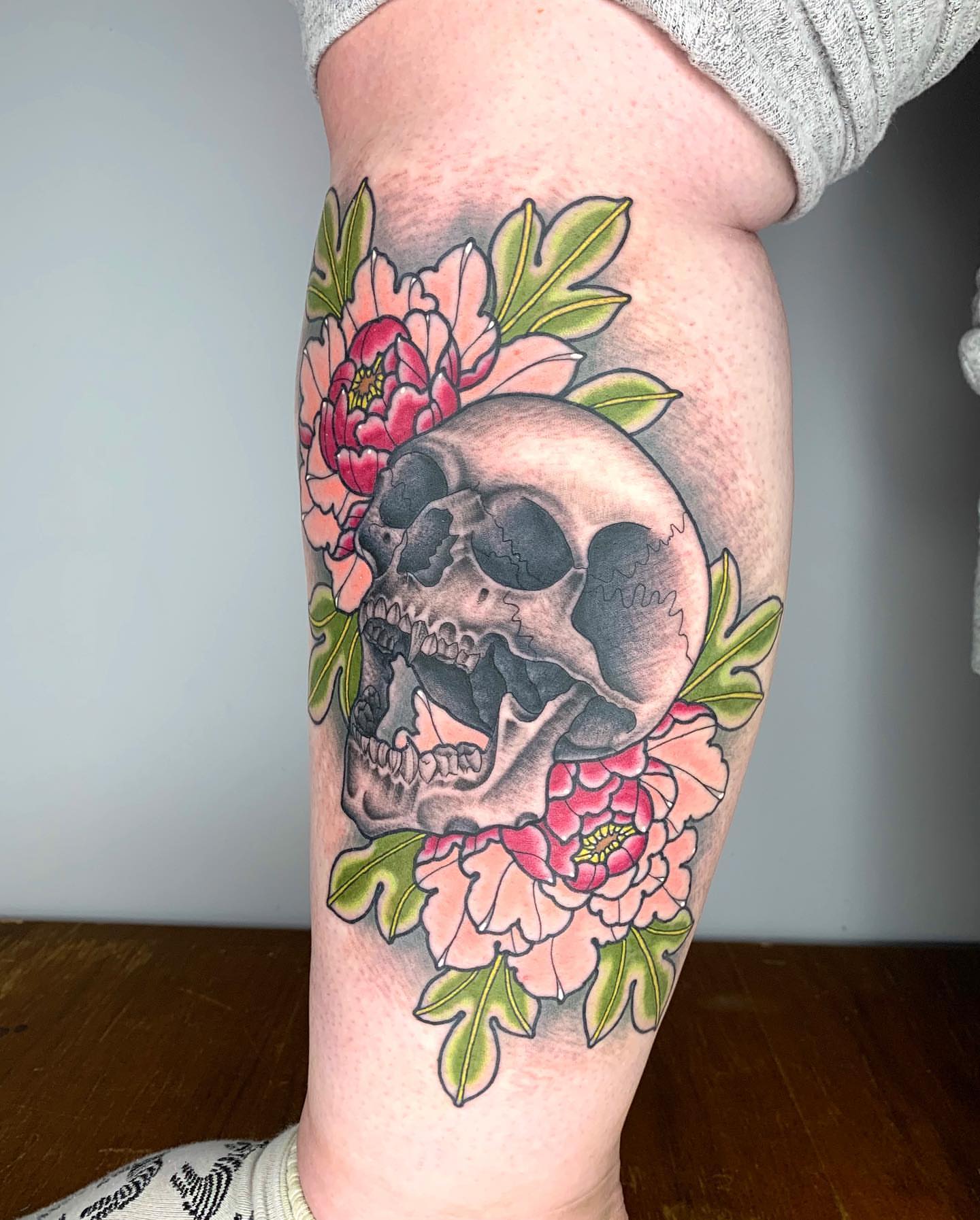 Skull and flowers American traditional tattoo on the forearm by Luis Torres, Harrison, New Jersey