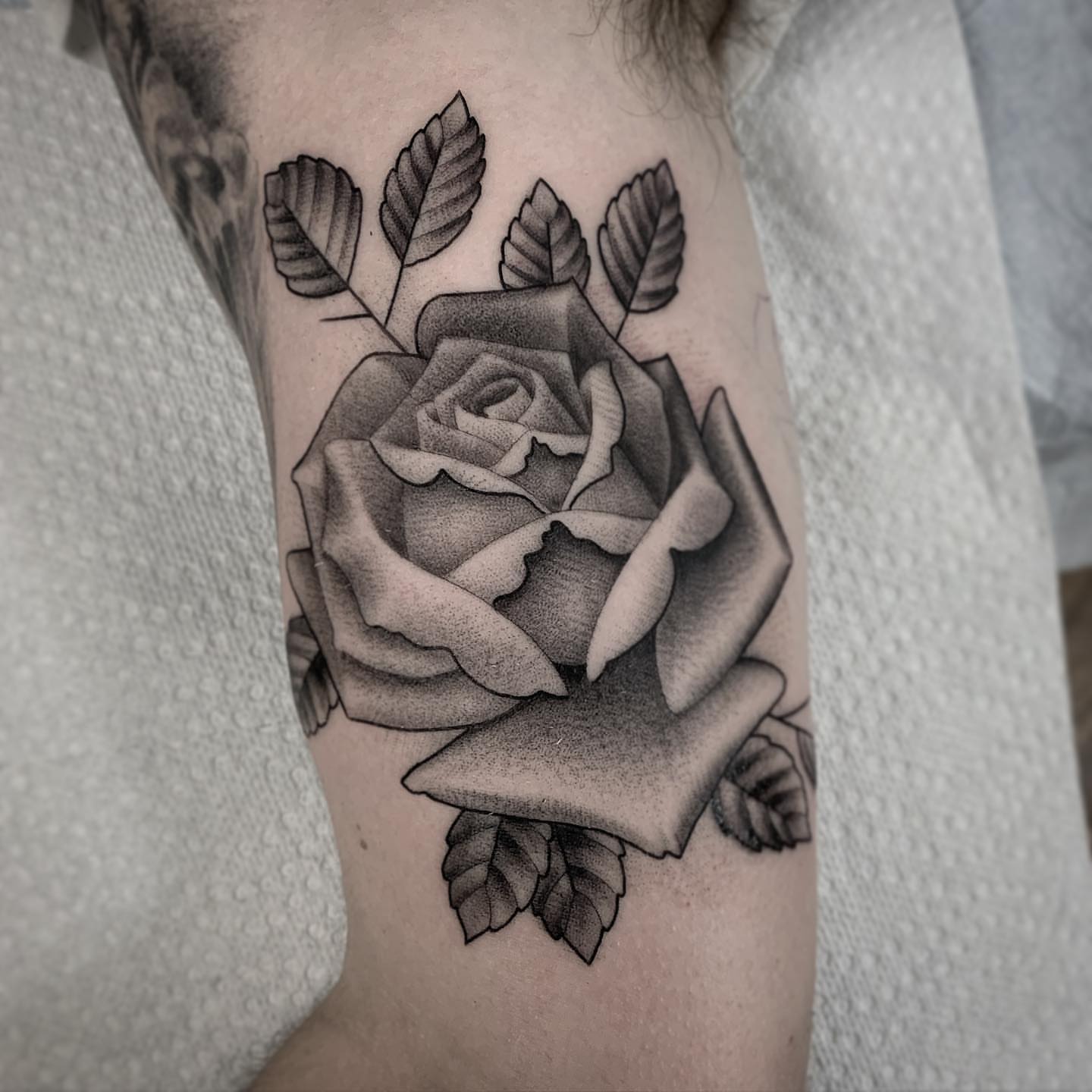 Rose black and grey tattoo on the forearm by Pat Moser
