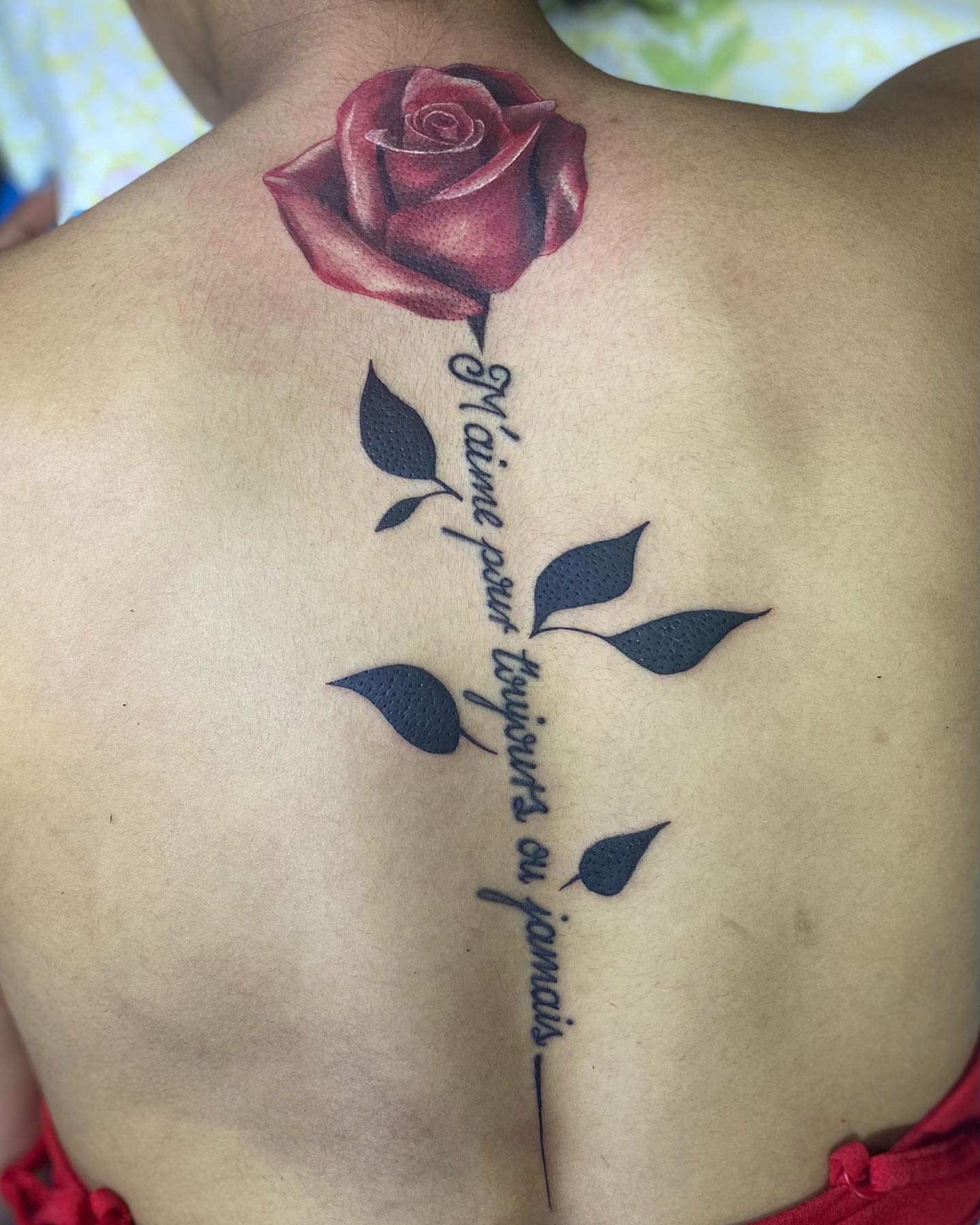 Red rose realism tattoo on the back by Alfonso Duenas