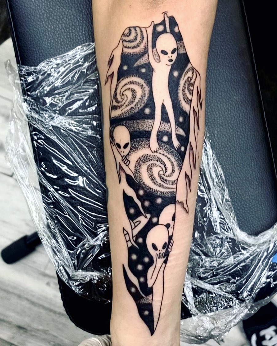 Aliens and spiral galaxy dotwork tattoo on the forearm by Monique Ortiz, Mesa, Arizona