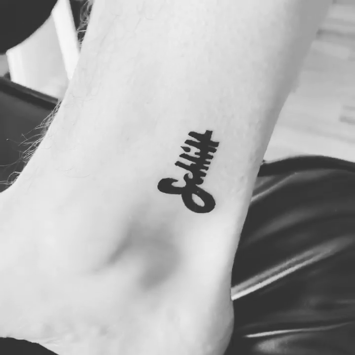 Schitt's Creek logo lettering tattoo on the foot by Rhonda Faber Green