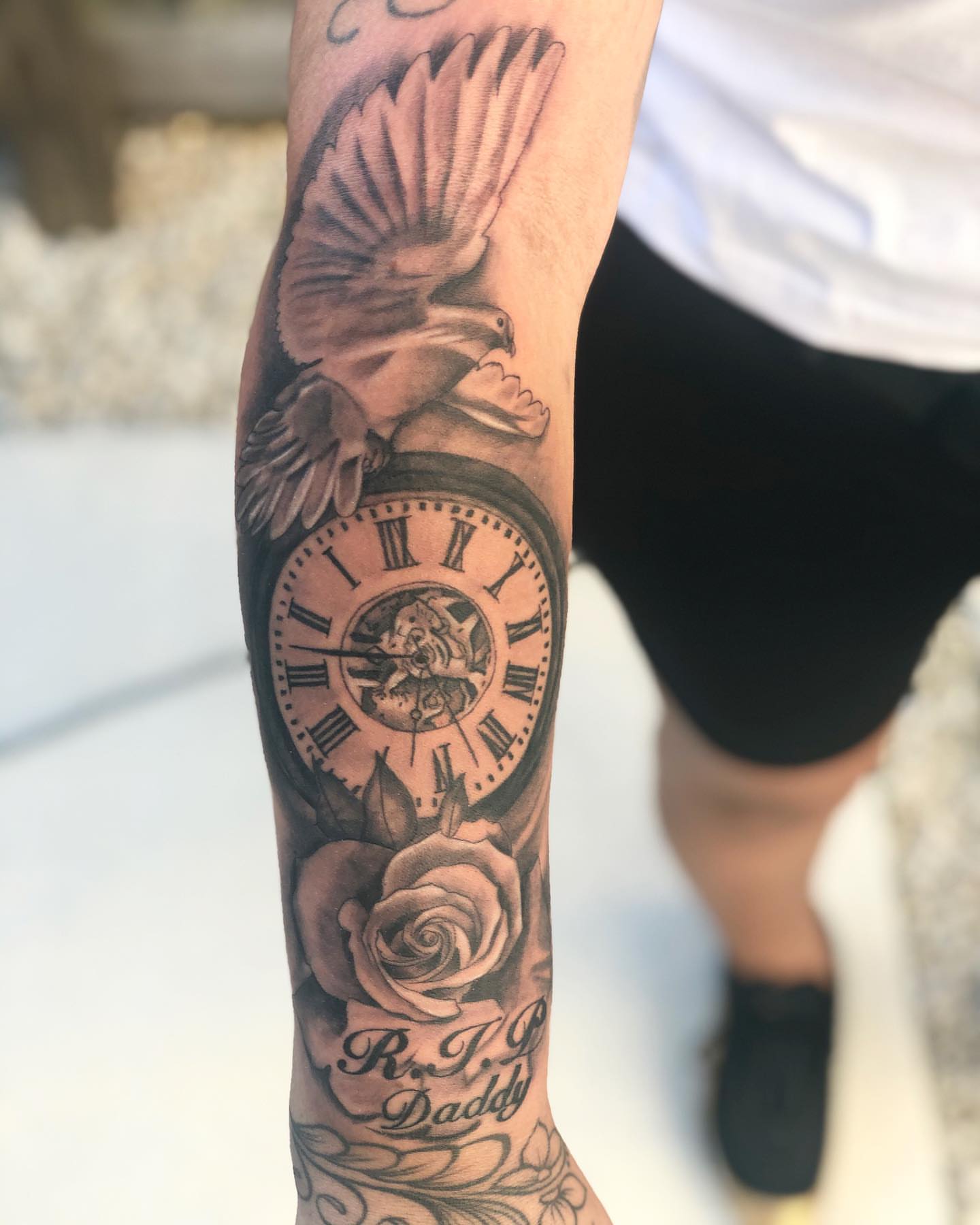 Clock and dove realism tattoo on the forearm by Kevin Palma