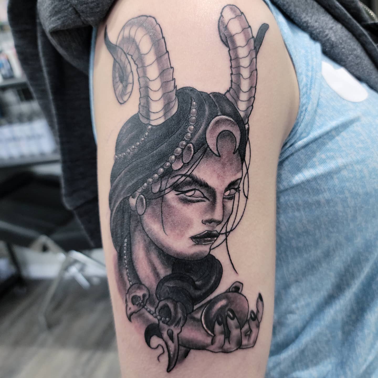 Woman with horns realism tattoo on the shoulder by Dick Eckman