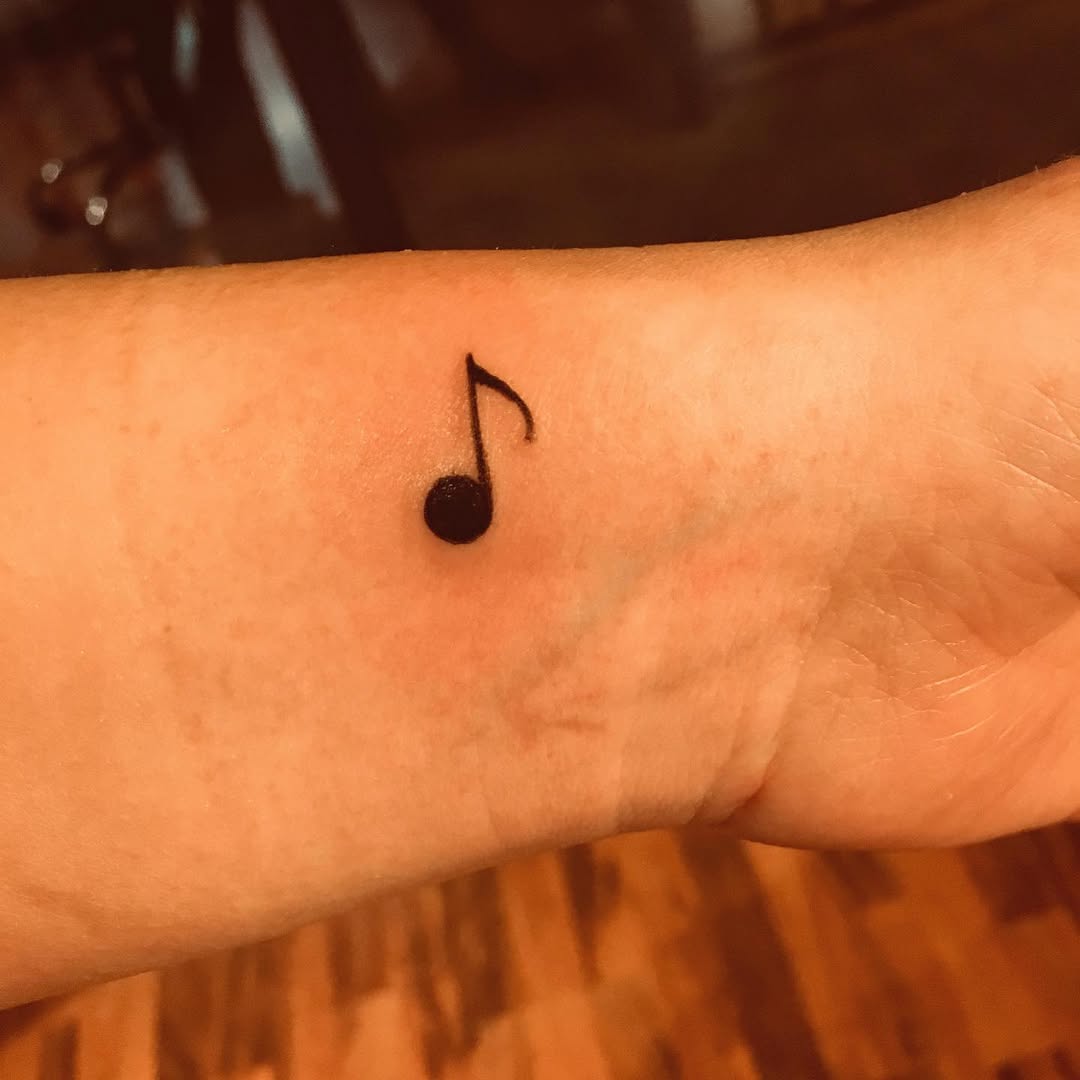 Musical note tattoo on the forearm by Rhonda Faber Green