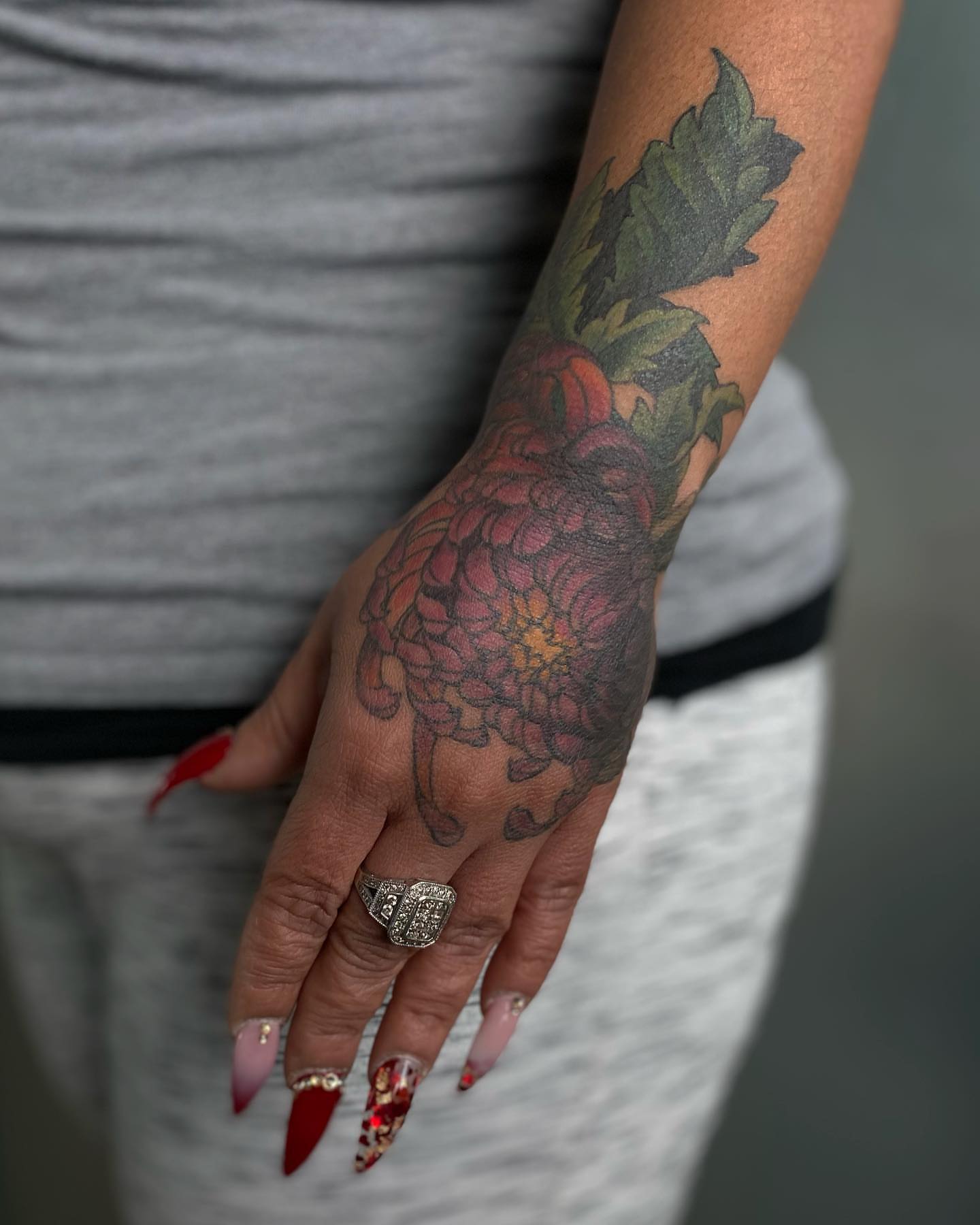Floral black and grey tattoo on the forearm by Rusty Indigo